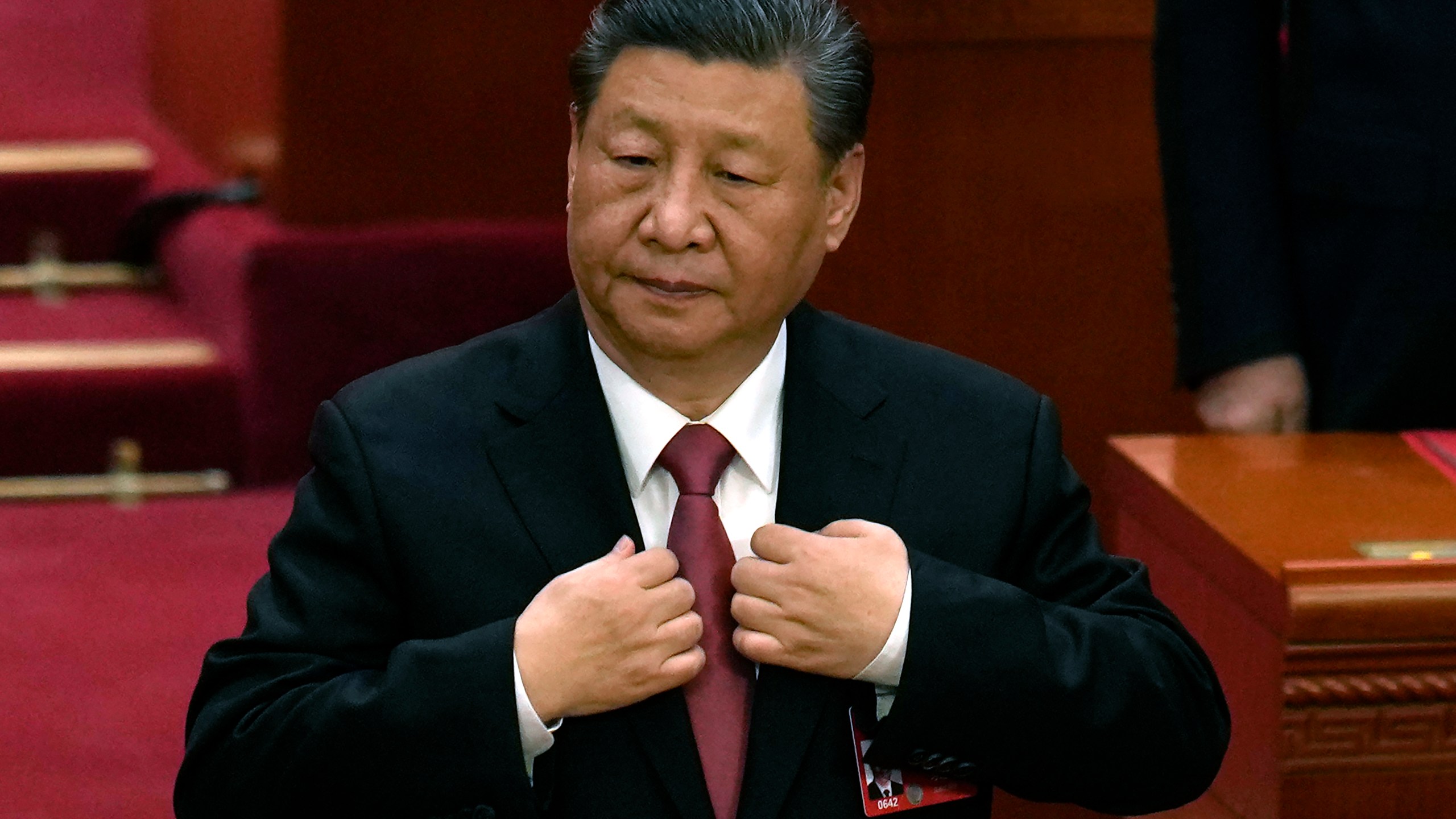 Chinese President Xi Jinping adjusts his jacket during the closing session of the National People's Congress held at the Great Hall of the People in Beijing, Monday, March 11, 2024. This year, China's national legislature resumed its annual in-person meetings in a way that it hadn't done since before the pandemic. Though officials say China is back to business, in practice, the meetings have become even more tightly scripted to broadcast Chinese leader Xi Jinping's message, leaving little room for the spontaneity and open engagement the sessions once offered before COVID-19. (AP Photo/Ng Han Guan)