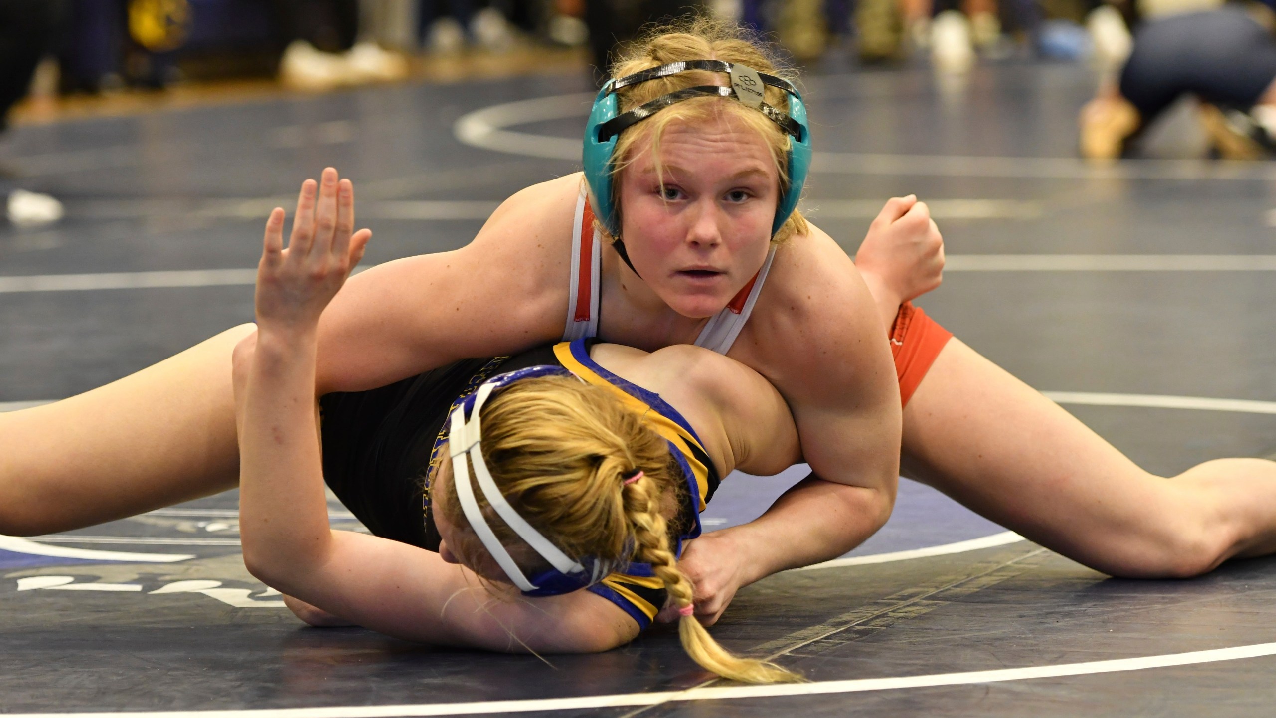 Easton Area High School wrestler Aubre Krazer, top, competes in a semifinal match during the Southeast Regional wrestling tournament Sunday, Feb. 25, 2024, in Quakertown, Pa. Girls’ wrestling has become the fastest-growing high school sport in the country. (AP Photo/Marc Levy)