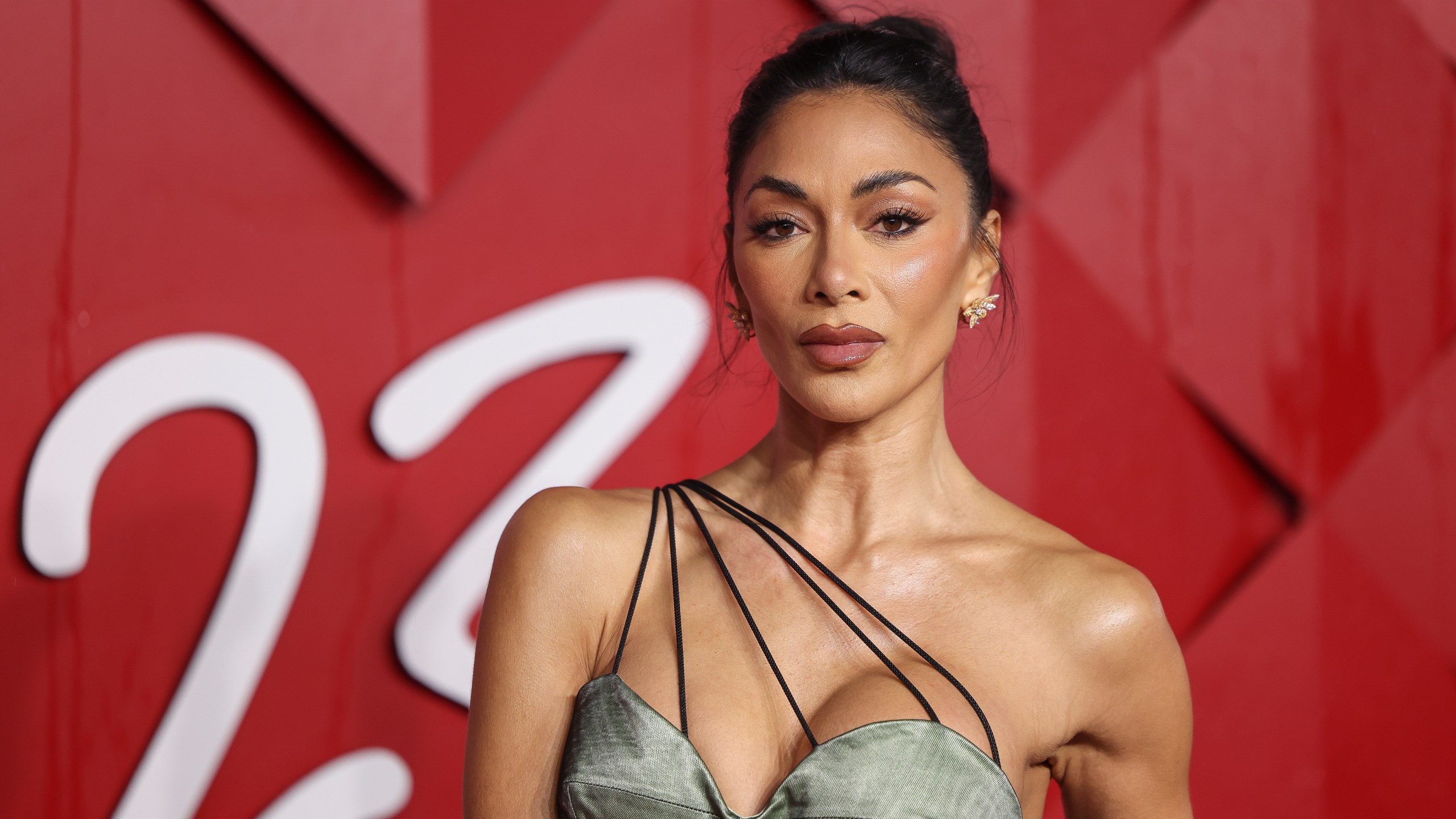 FILE - Nicole Scherzinger poses for photographers upon arrival at the British Fashion Awards, Dec. 4, 2023 in London. An acclaimed revival of Andrew Lloyd Webber’s “Sunset Boulevard” and a play about the travails of England’s national soccer team lead the race for the Olivier Awards recognizing work on the London stage. The 11 nominations for “Sunset Boulevard” include best actress in a musical for Nicole Scherzinger. Winners will be announced April 14 in a ceremony at London’s Royal Albert Hall. (Vianney Le Caer/Invision/AP, File)