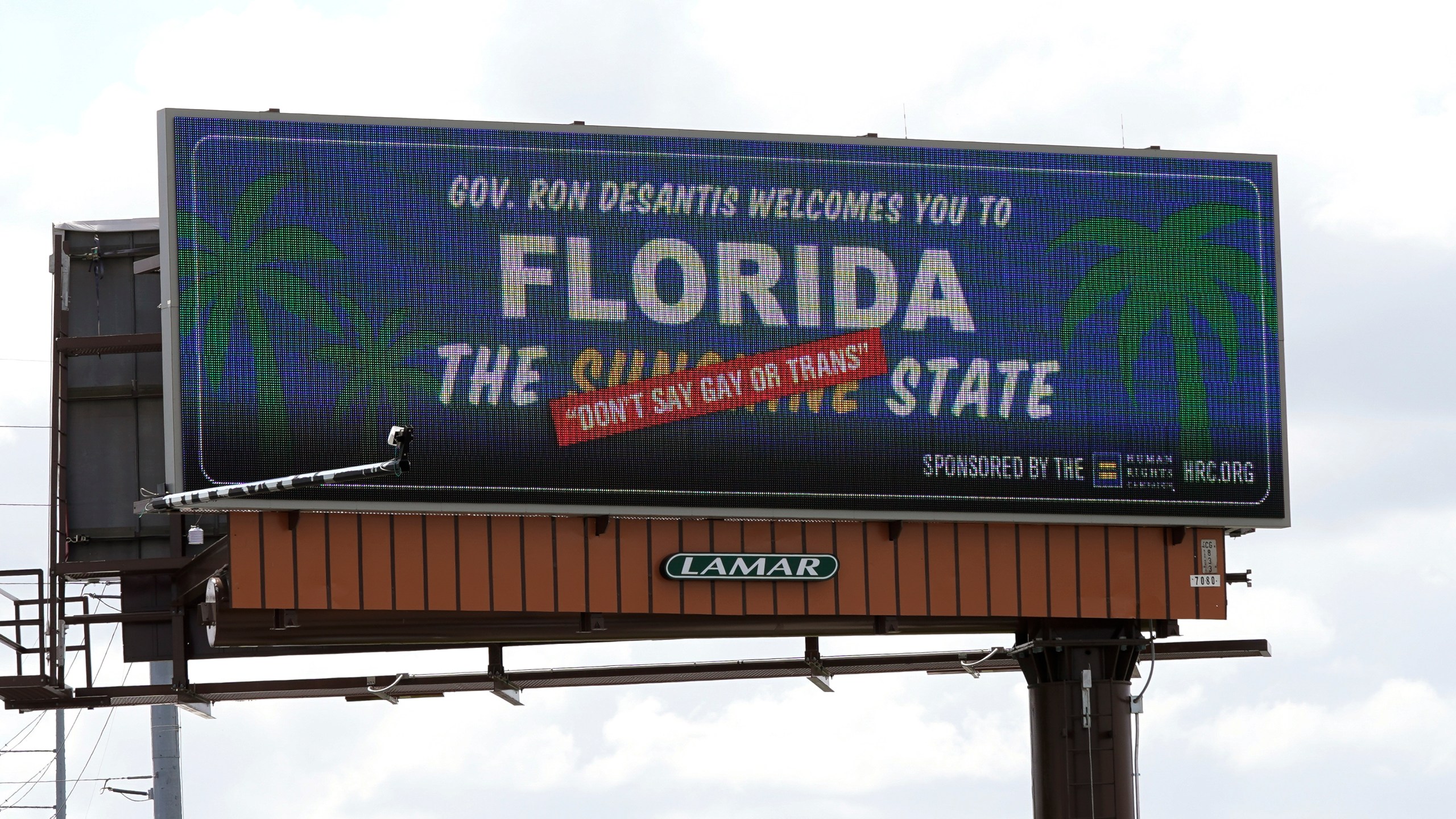 FILE - A new billboard welcoming visitors to "Florida: The Sunshine 'Don't Say Gay or Trans' State," is seen on April 21, 2022, in Orlando, Fla. Florida's state government and LGBTQ+ advocates have settled a lawsuit challenging a law that bars teaching about sexual orientation and gender identity in public schools. (AP Photo/John Raoux, File)