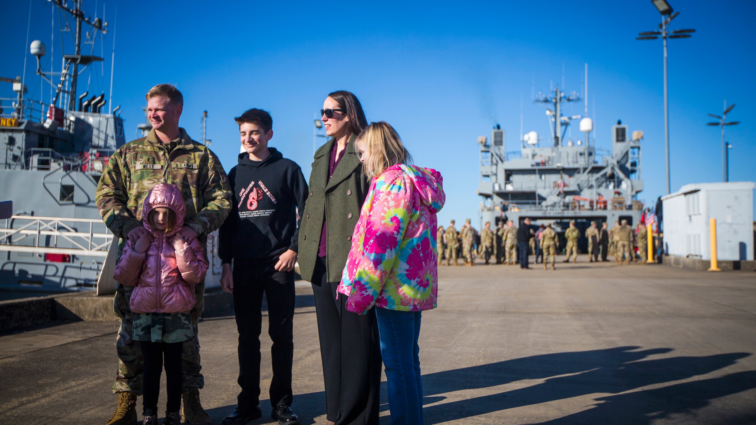 CW3 Jason West, left, skipper for LSV SP/4 James A. Loux, 7th Transportation Brigade (Expeditionary), stands with his family before deploying on Tuesday, March 12, 2024, at Joint Base Langley-Eustis in Hampton, Va. (AP Photo/John C. Clark)