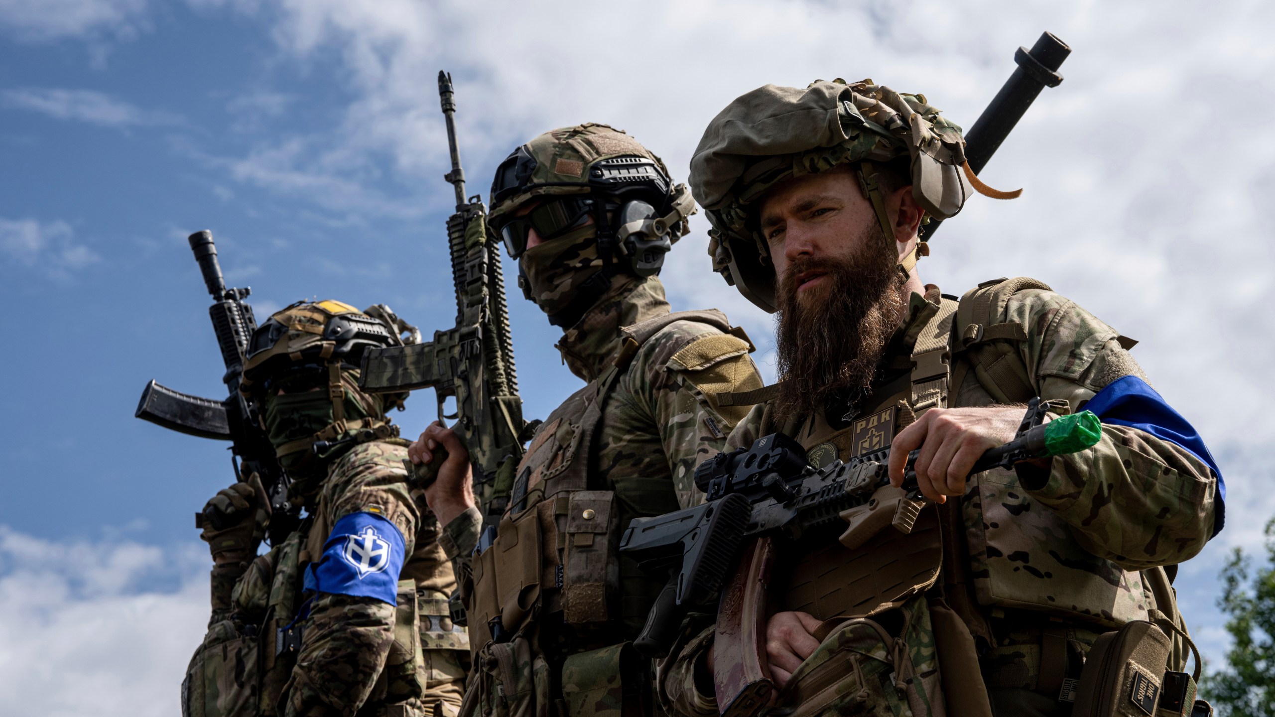 FILE - Fighters of Russian Volunteer Corps stand atop on an APC during press conference not far from the Ukraine's border with Russia in Sumy region, Ukraine, on May 24, 2023. Fighters from Ukraine made an attempt to cross into the town of Tetkino, which lies right on the border, the governor of Russia’s Kursk region, Roman Starovoit, said Tuesday. (AP Photo/Evgeniy Maloletka, File)