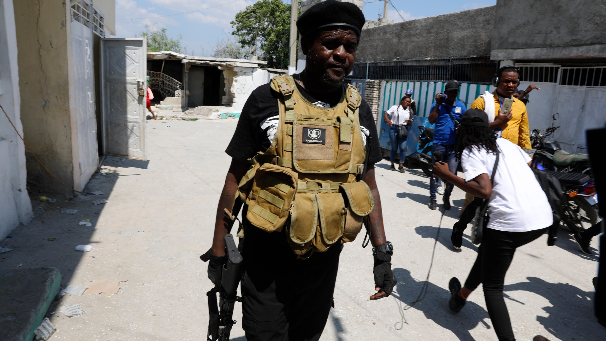 Jimmy Chérizier, a former elite police officer known as Barbecue who leads the G9 and Family gang, walks away after speaking to journalists in the Delmas 6 neighborhood of Port-au-Prince, Haiti, Monday, March 11, 2024. (AP Photo/Odelyn Joseph)