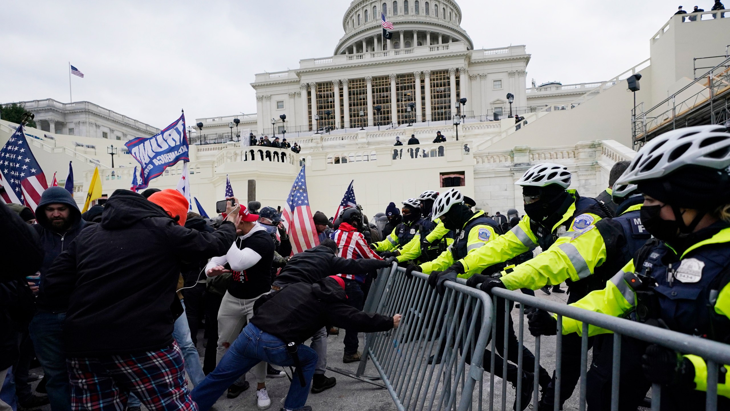 FILE - Rioters loyal to President Donald Trump push against a line of police at the U.S. Capitol in Washington on Jan. 6, 2021. House Republicans are aiming to undercut the Jan. 6 Committee's investigation with a new report that they say contradicts some of key testimony given to the panel. (AP Photo/Julio Cortez, File)