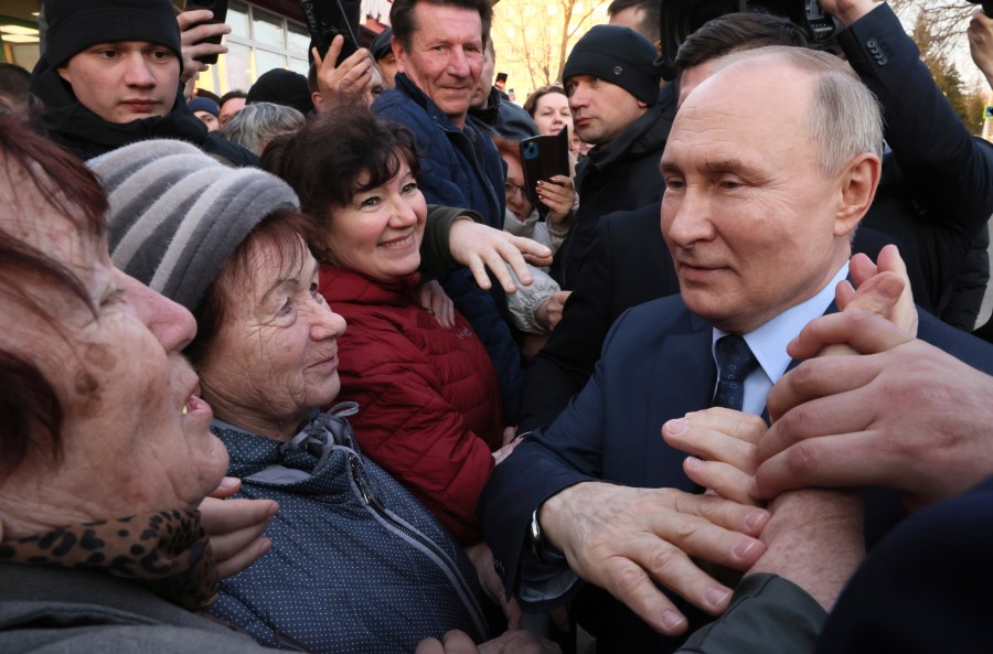 FILE - Russian President Vladimir Putin meets with residents following a visit to the Solnechniy Dar greenhouse complex, part of the ECO-Culture agro-industrial holding, outside Stavropol, Russia, on Tuesday, March 5, 2024. Putin is poised to sweep to another six-year term in the March 15-17 presidential election, relying on his rigid control of the country established during his 24 years in power — the longest Kremlin tenure since Soviet leader Josef Stalin. (Mikhail Metzel, Sputnik, Kremlin Pool Photo via AP, File)