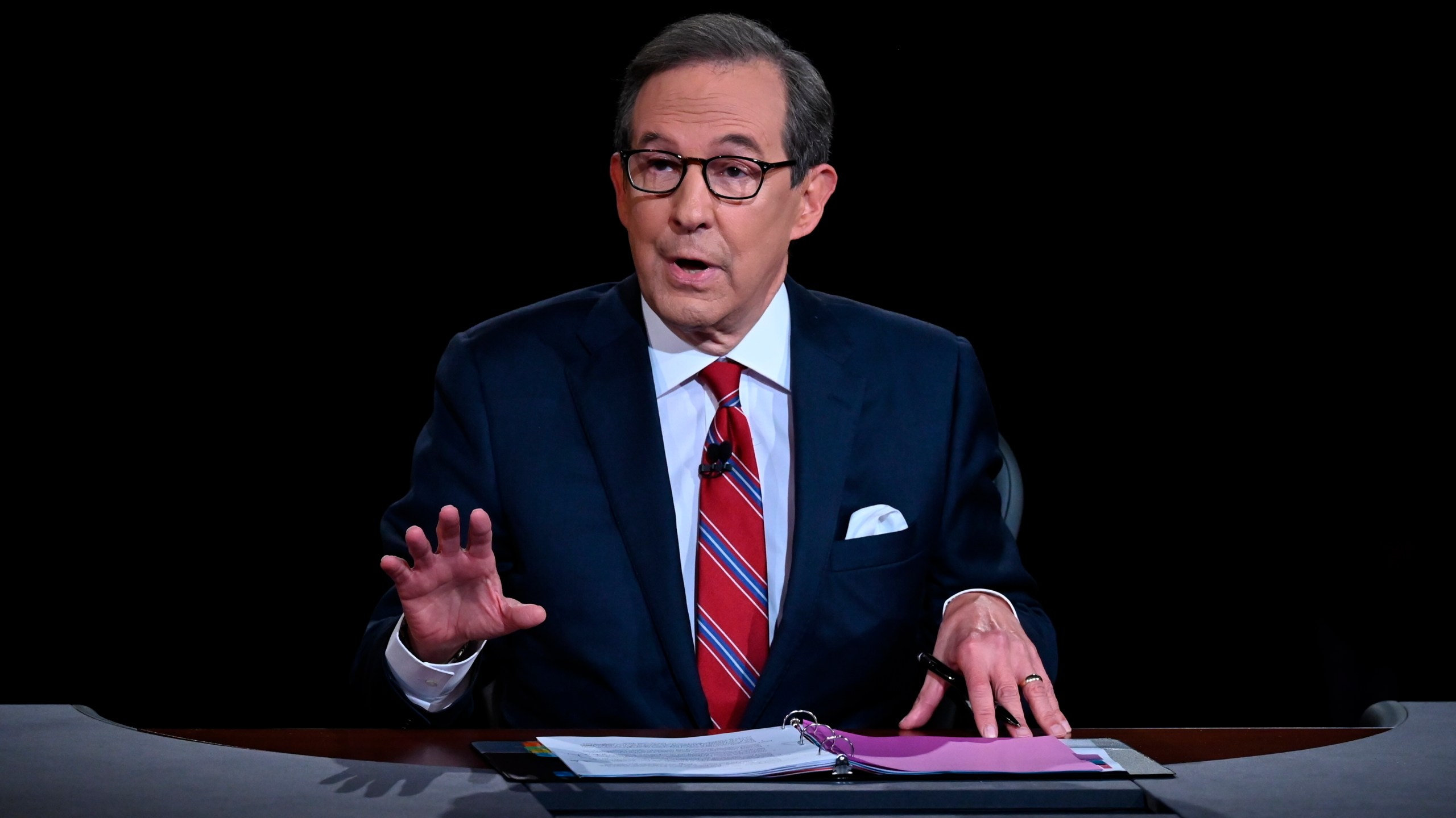 FILE - Moderator Chris Wallace speaks as President Donald Trump and Democratic presidential candidate former Vice President Joe Biden participate in the first presidential debate in Cleveland on Sept. 29, 2020. Wallace has written a book on the race between John F. Kennedy and Richard Nixon. The race was narrowly won by Kennedy and featured the first televised presidential debates. Dutton announced Wednesday that “Countdown 1960: The Behind-the-Scenes Story of the 311 Days that Changed America’s Politics Forever” will be published Oct. 8. (Olivier Douliery/Pool via AP, File)