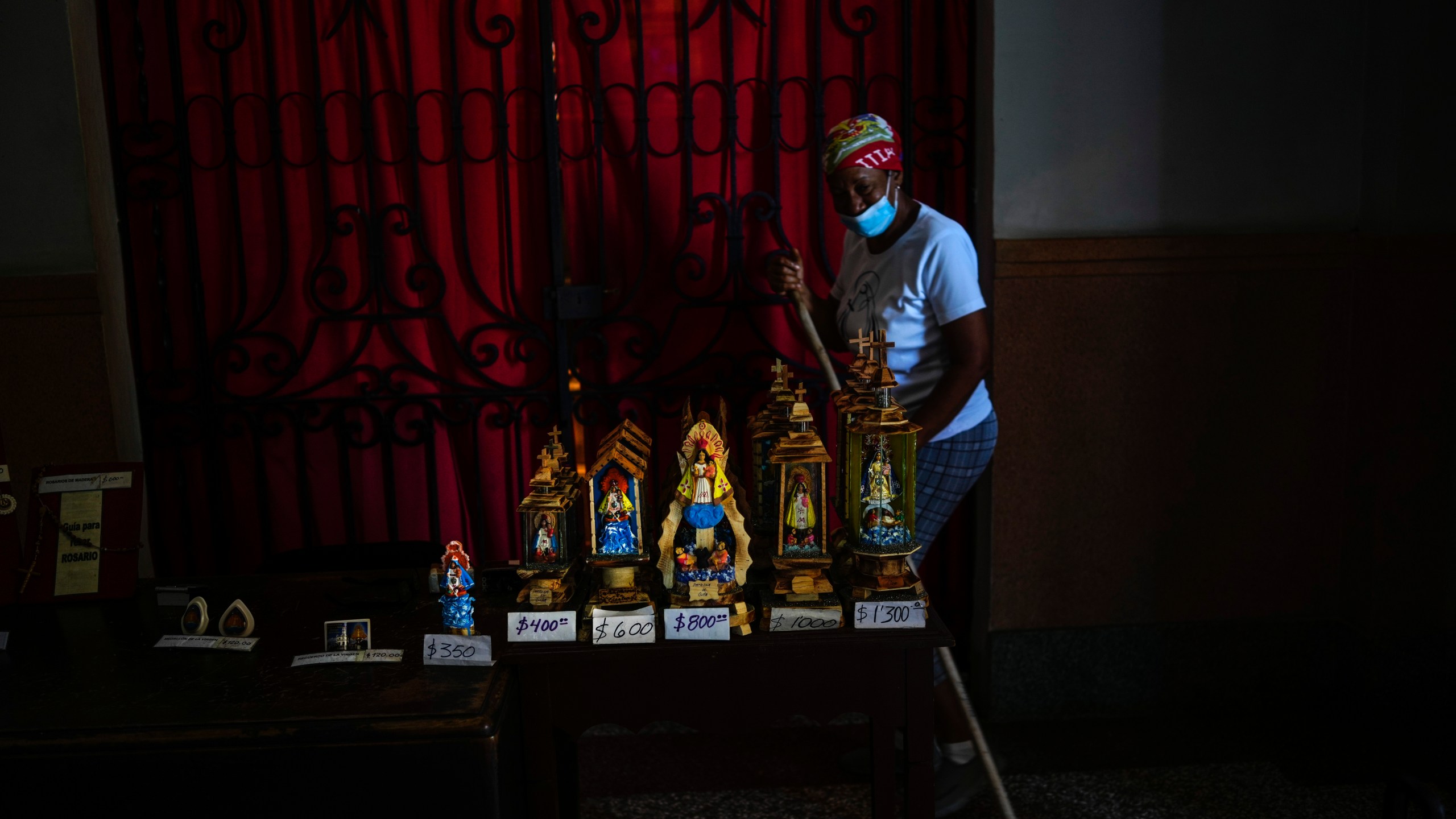 Statuettes of the Virgin of Charity of Cobre are for sale inside her shrine in El Cobre, Cuba, Saturday, Feb. 10, 2024. The Vatican-recognized Virgin, venerated by Catholics and followers of Afro-Cuban Santeria traditions, is at the heart of Cuban identity, uniting compatriots from the Communist-run Caribbean island to those who were exiled or emigrated to the U.S. (AP Photo/Ramon Espinosa)