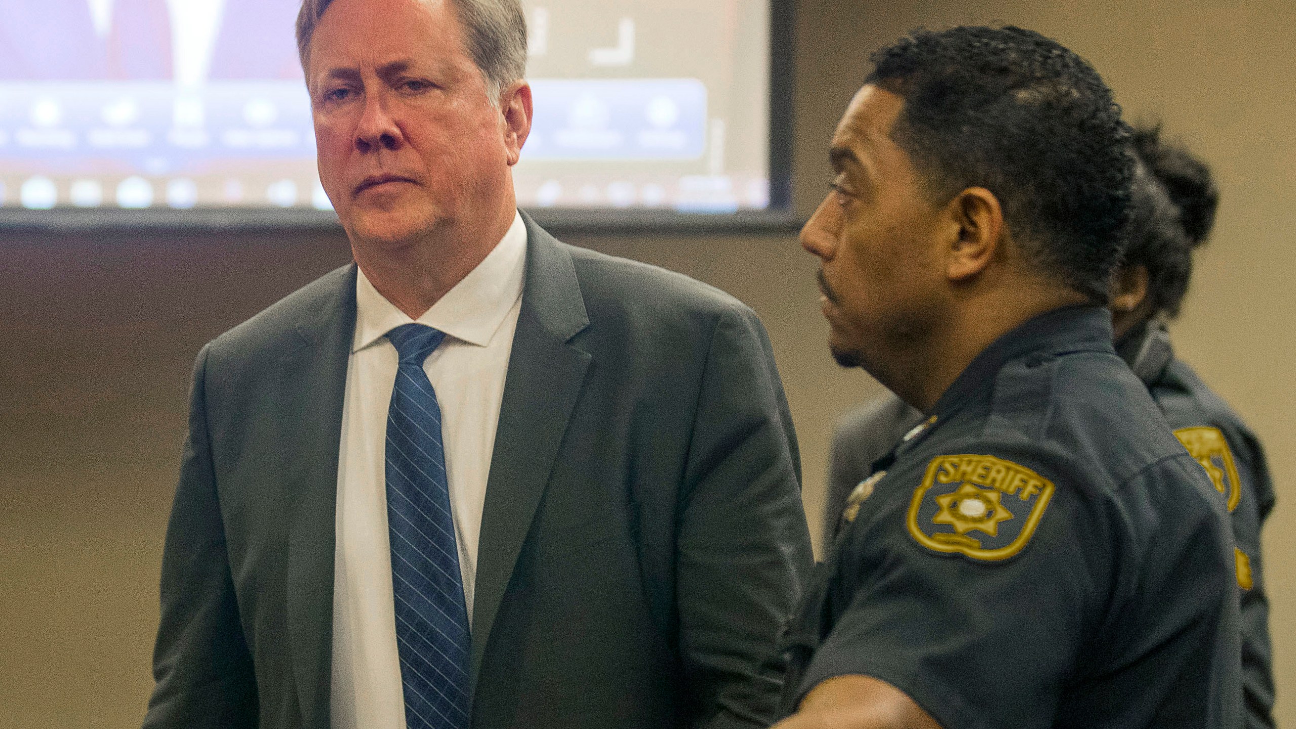 FILE - Former DeKalb County police officer Robert Olsen prepares to be processed after his sentencing, Friday, Nov. 1, 2019, in Decatur, Ga. An appeals court has overturned the convictions of Olsen, Wednesday, March 13, 2024, who shot and killed an unarmed, naked man. (Alyssa Pointer/Atlanta Journal-Constitution via AP)