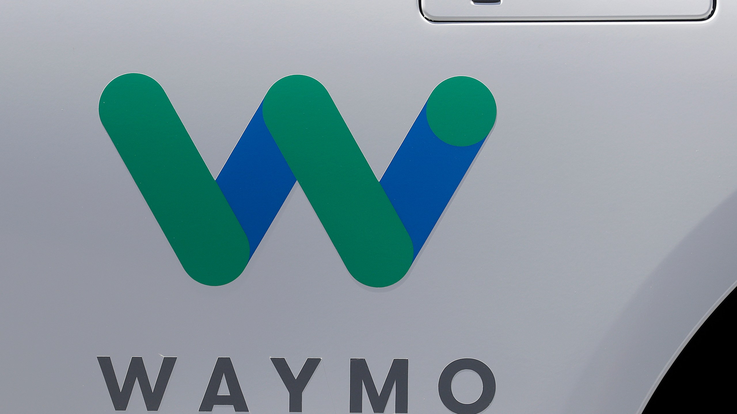 FILE - In this May 8, 2018, file photo, a Waymo logo is displayed on the door of a car at the Google I/O conference in Mountain View, Calif. Robotaxis are hitting the streets of Los Angeles. Google spinoff Waymo says on Thursday, March 14, 2024 it will begin offering free rides to a some of the roughly 50,000 people who have signed up for its driverless ride-hailing service in the second largest U.S. city. (AP Photo/Jeff Chiu, File)