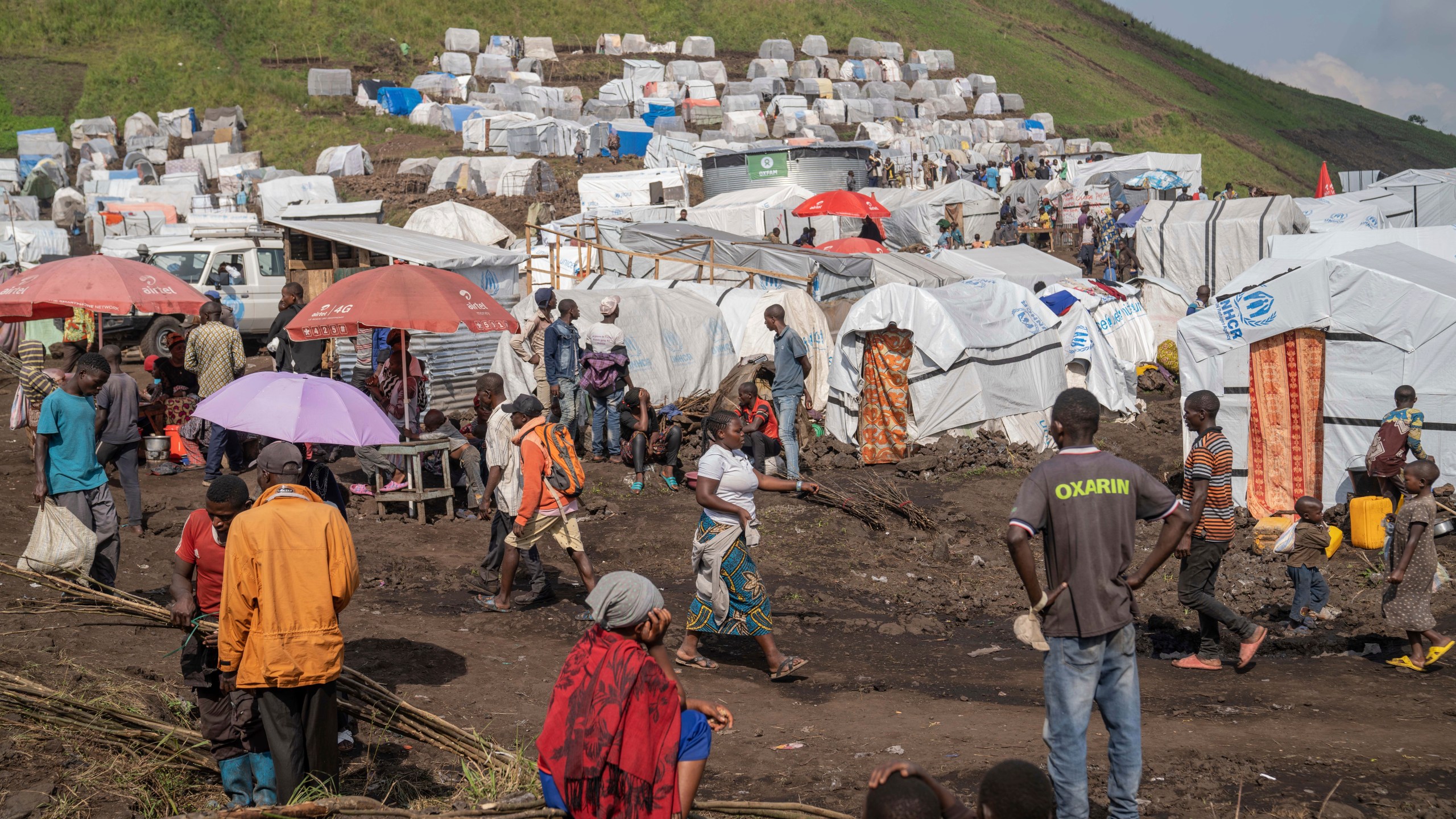 People displaced by the ongoing fighting between Congolese forces and M23 rebels gather in a camp on the outskirts of Goma, Democratic Republic of Congo, Wednesday, March 13, 2024, as OCHA (United Nations Office for the Coordination of Humanitarian Affairs) head and representative Ramesh Rajasingham, carries out a working visit to the region. (AP Photo/Moses Sawasawa)