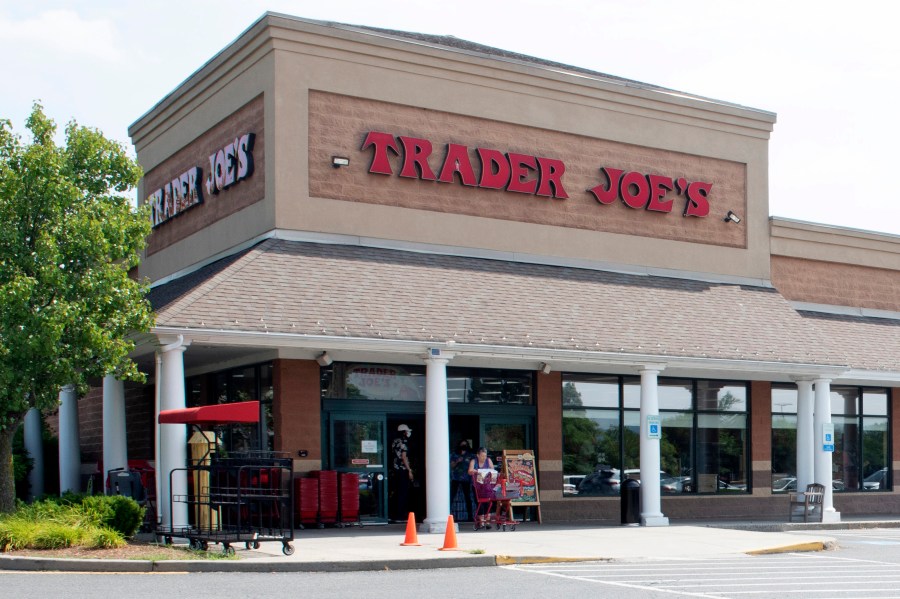 FILE - A shopper pushes a cart from the Trader Joe's supermarket on July 28, 2022, in Hadley, Mass. Trader Joe's mini canvas tote is the latest item to cause a stir on social media, so much so that resellers are taking advantage of the hype. (Carol Lollis/The Daily Hampshire Gazette via AP, File)