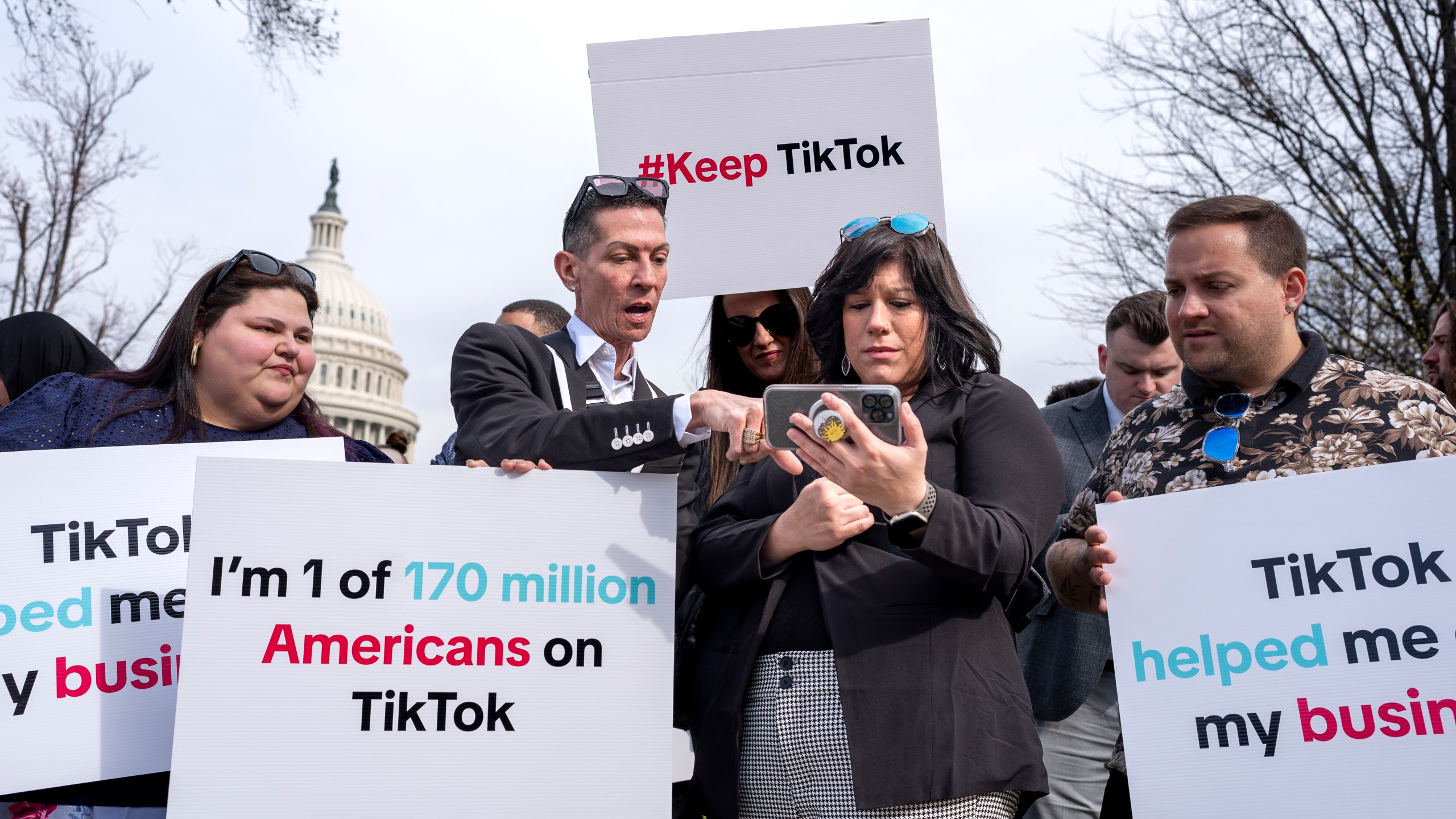 Devotees of TikTok monitor voting at the Capitol in Washington, as the House passed a bill that would lead to a nationwide ban of the popular video app if its China-based owner doesn't sell, Wednesday, March 13, 2024. Lawmakers contend the app's owner, ByteDance, is beholden to the Chinese government, which could demand access to the data of TikTok's consumers in the U.S. (AP Photo/J. Scott Applewhite)