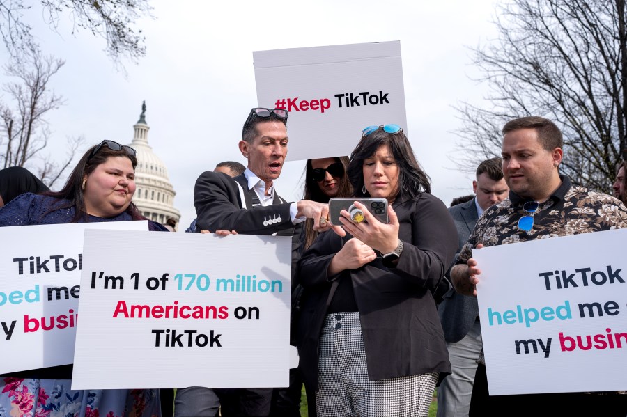 Devotees of TikTok monitor voting at the Capitol in Washington, as the House passed a bill that would lead to a nationwide ban of the popular video app if its China-based owner doesn't sell, Wednesday, March 13, 2024. Lawmakers contend the app's owner, ByteDance, is beholden to the Chinese government, which could demand access to the data of TikTok's consumers in the U.S. (AP Photo/J. Scott Applewhite)