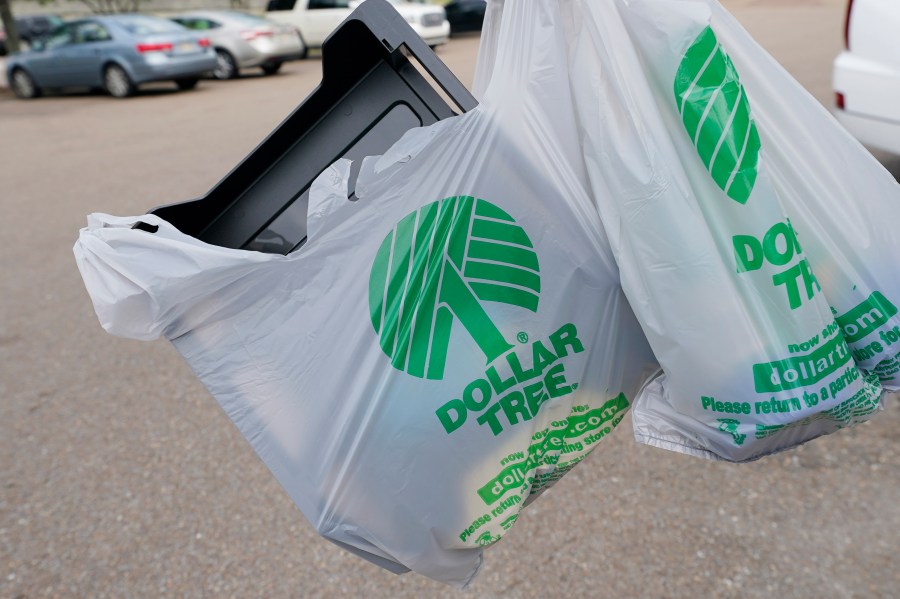 FILE - A customer exits a Dollar Tree store holding a shopping bag on Wednesday, May 11, 2022, in Jackson, Miss. Dollar Tree says it plans to close nearly 1,000 stores and moved to a surprise loss in its fiscal fourth quarter as the discount retailer took a $1.07 billion goodwill impairment charge. Shares dropped more than 7% before the market open on Wednesday, March 13, 2024. (AP Photo/Rogelio V. Solis, File)