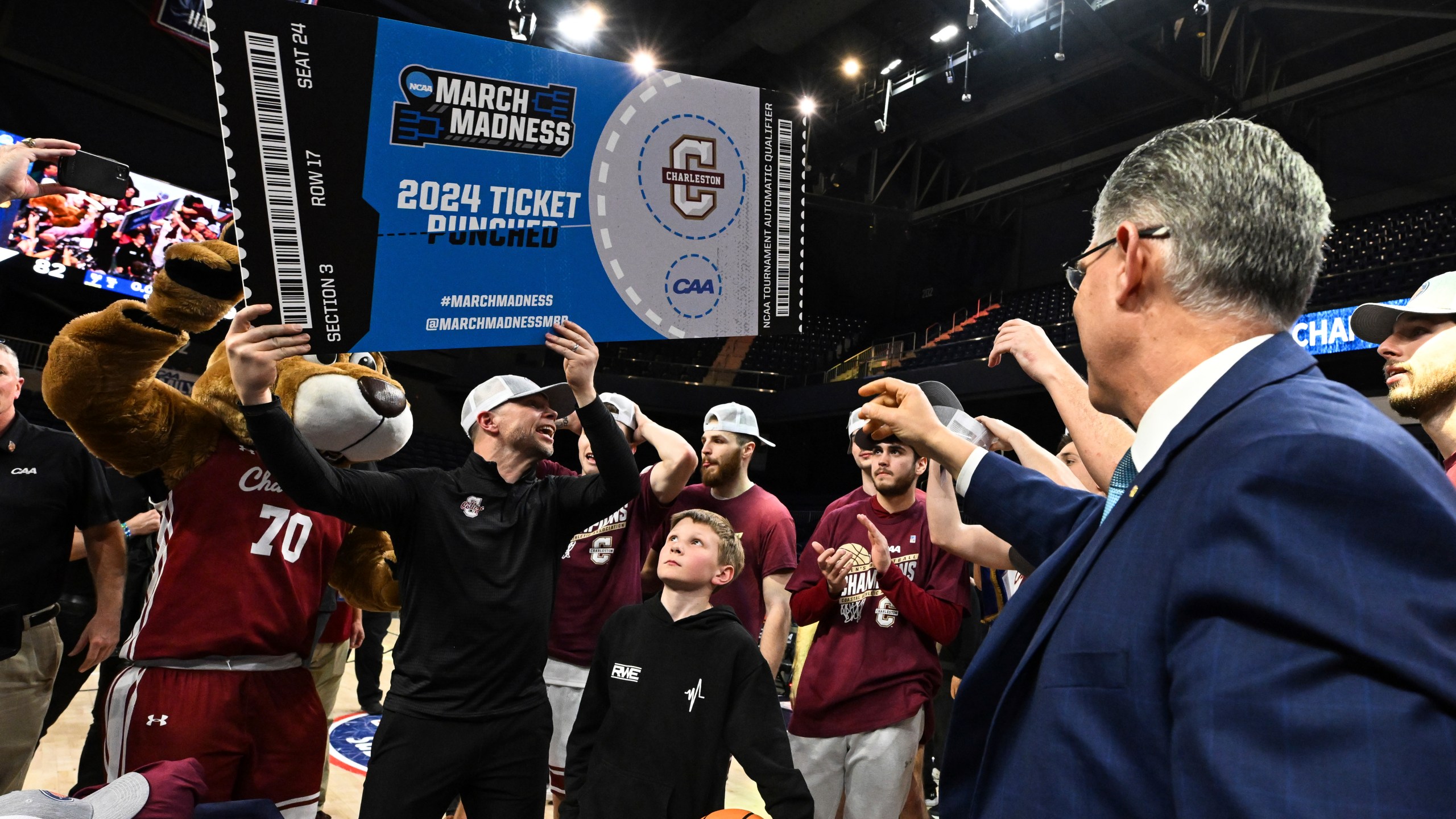 Charleston head coach Pat Kelsey holds a March Madness ticket after defeating Stony Brook in the NCAA college basketball game in the championship of the Coastal Athletic Association conference tournament, Tuesday, March 12, 2024, in Washington. (AP Photo/Terrance Williams)