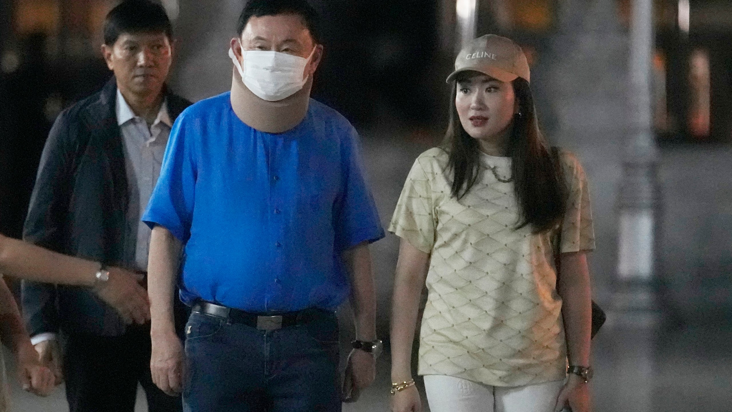 Former Thai Prime Minister Thaksin Shinawatra, center, and his daughter Paetongtarn Shinawatra, right, visit City Pillar Shrine in Bangkok, Thailand, Thursday, March 14, 2024. Earlier in February, he was released on parole from a hospital where he spent six months serving time for corruption-related offenses. (AP Photo/Sakchai Lalit)