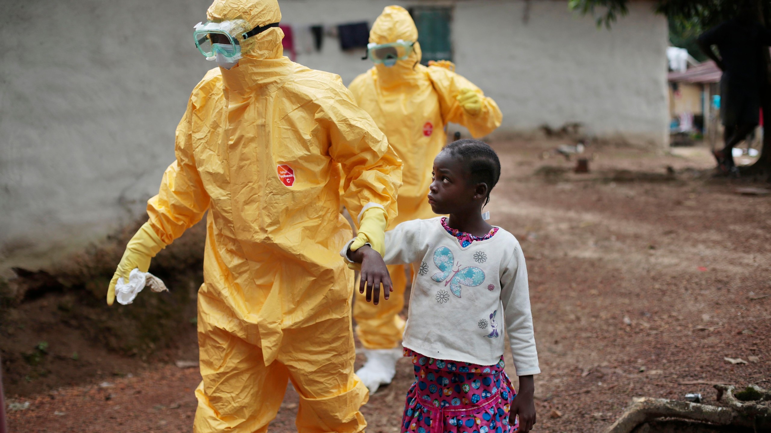 FILE - Nowa Paye, 9, is taken to an ambulance after showing signs of the Ebola infection in the village of Freeman Reserve, about 30 miles north of Monrovia, Liberia, on Sept. 30, 2014. Liberians gathered Wednesday, March 13, 2024 to commemorate a decade since the country was first hit by a devastating outbreak of Ebola that killed thousands in West Africa, adding to the region's economic and political troubles. (AP Photo/Jerome Delay, File)