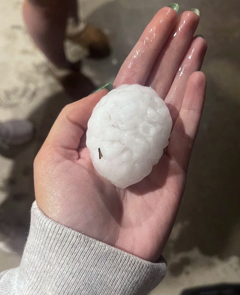 In this image provided by Jeremy Crabtree, large chunks of hail are shown, Wednesday night, March 13, 2024, in Shawnee, Kan. Volatile weather was honing in on parts of Kansas and Missouri Wednesday night, with some storms bringing massive chunks of hail. (Jeremy Crabtree via AP)