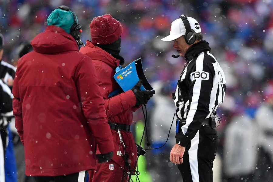 FILE - Referee Land Clark reviews a play during the second half of an NFL football game between the Buffalo Bills and the Atlanta Falcons in Orchard Park, N.Y., Jan. 2, 2022. The Indianapolis Colts are proposing a rule change that would allow for challenges of penalty calls in the last two minutes of the half. The NFL released a list of several rule change proposals Wednesday, March 13, made by teams. (AP Photo/Adrian Kraus, File)