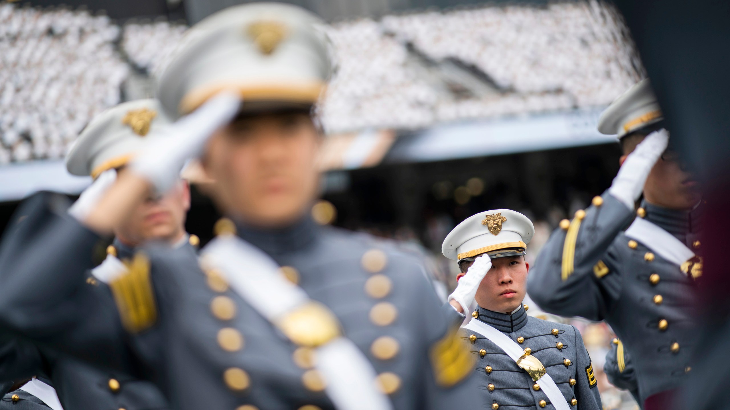 FILE - Graduating cadets salute during the graduation ceremony of the U.S. Military Academy class of 2021, Saturday, May 22, 2021, in West Point, N.Y. "Duty, Honor, County" has been the motto of the U.S. Military Academy at West Point since 1898. The motto isn't changing, but a decision to take those words out of the school's lesser-known mission statement is generating outrage in certain quarters. (AP Photo/Eduardo Munoz Alvarez, File)