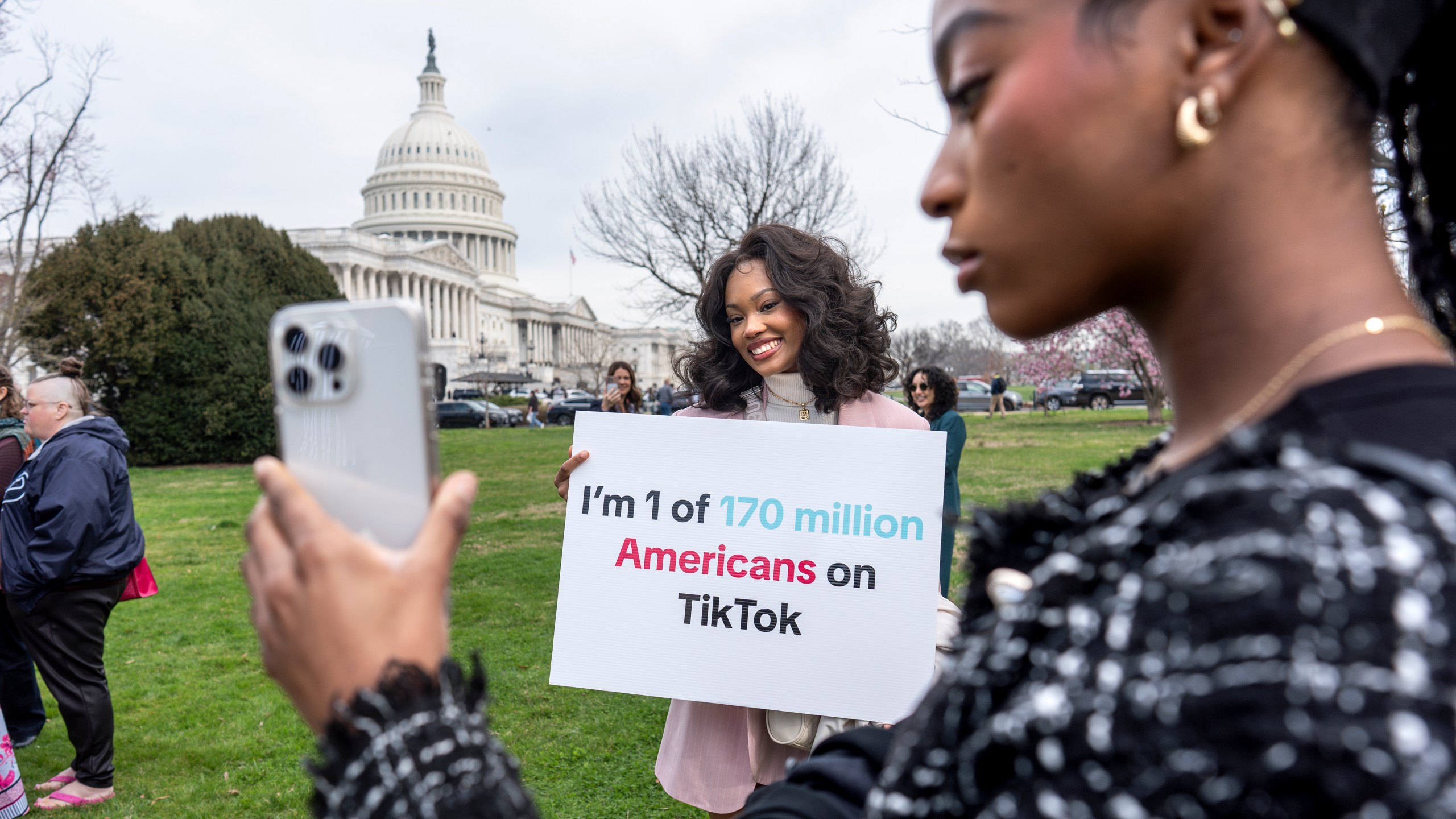 FILE - Devotees of TikTok, Mona Swain, center, and her sister, Rachel Swain, right, both of Atlanta, monitor voting at the Capitol in Washington, as the House passed a bill that would lead to a nationwide ban of the popular video app if its China-based owner doesn't sell, March 13, 2024. If some U.S. lawmakers have their way, the United States and China could end up with something in common: TikTok might not be available in either country. (AP Photo/J. Scott Applewhite, File)