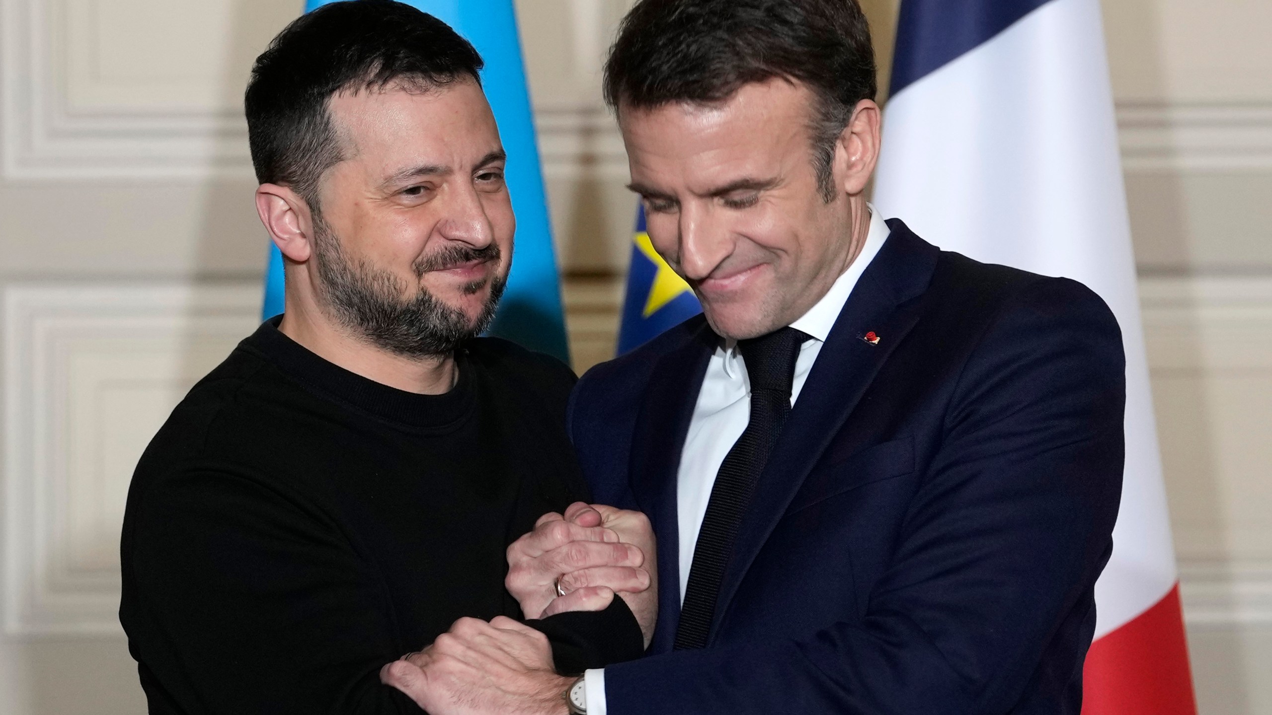 FILE - Ukrainian President Volodymyr Zelenskyy, left, and French President Emmanuel Macron shake hands after a press conference, on Feb. 16, 2024 at the Elysee Palace in Paris. French President Emmanuel Macron is to speak on national television on Thursday March 14, 2024 evening about how to further support Ukraine and the challenges faced by Europe, after saying last month the possibility of sending Western troops in the war-torn country could not be ruled out. (AP Photo/Thibault Camus, Pool, File)