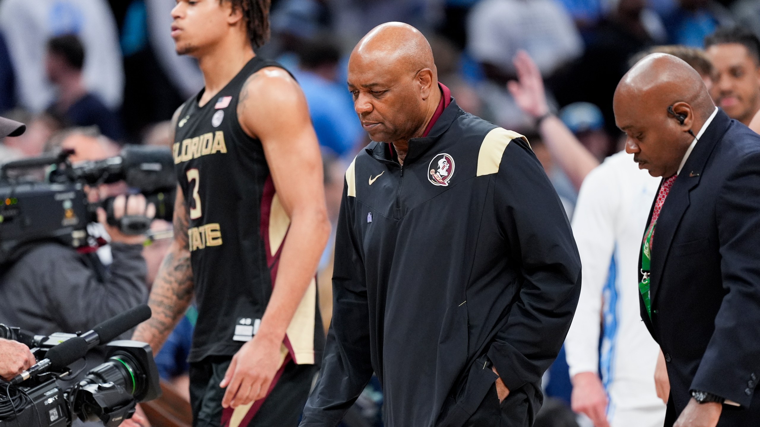 Florida State forward Cam Corhen (3) and head coach Leonard Hamilton leave the court following of an NCAA college basketball game against North Carolina in the quarterfinal round of the Atlantic Coast Conference tournament, Thursday, March 14, 2024, in Washington. (AP Photo/Susan Walsh)
