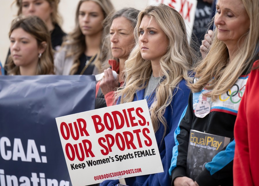 FILE - Former University of Kentucky swimmer Riley Gaines, second from right, stands during a rally on Thursday, Jan. 12, 2023, outside of the NCAA Convention in San Antonio. Gaines was among more than a dozen college athletes who filed a lawsuit against the NCAA on Thursday, March 14, 2023, accusing it of violating their Title IX rights by allowing Lia Thomas to compete at national championships in 2022. (AP Photo/Darren Abate, File)