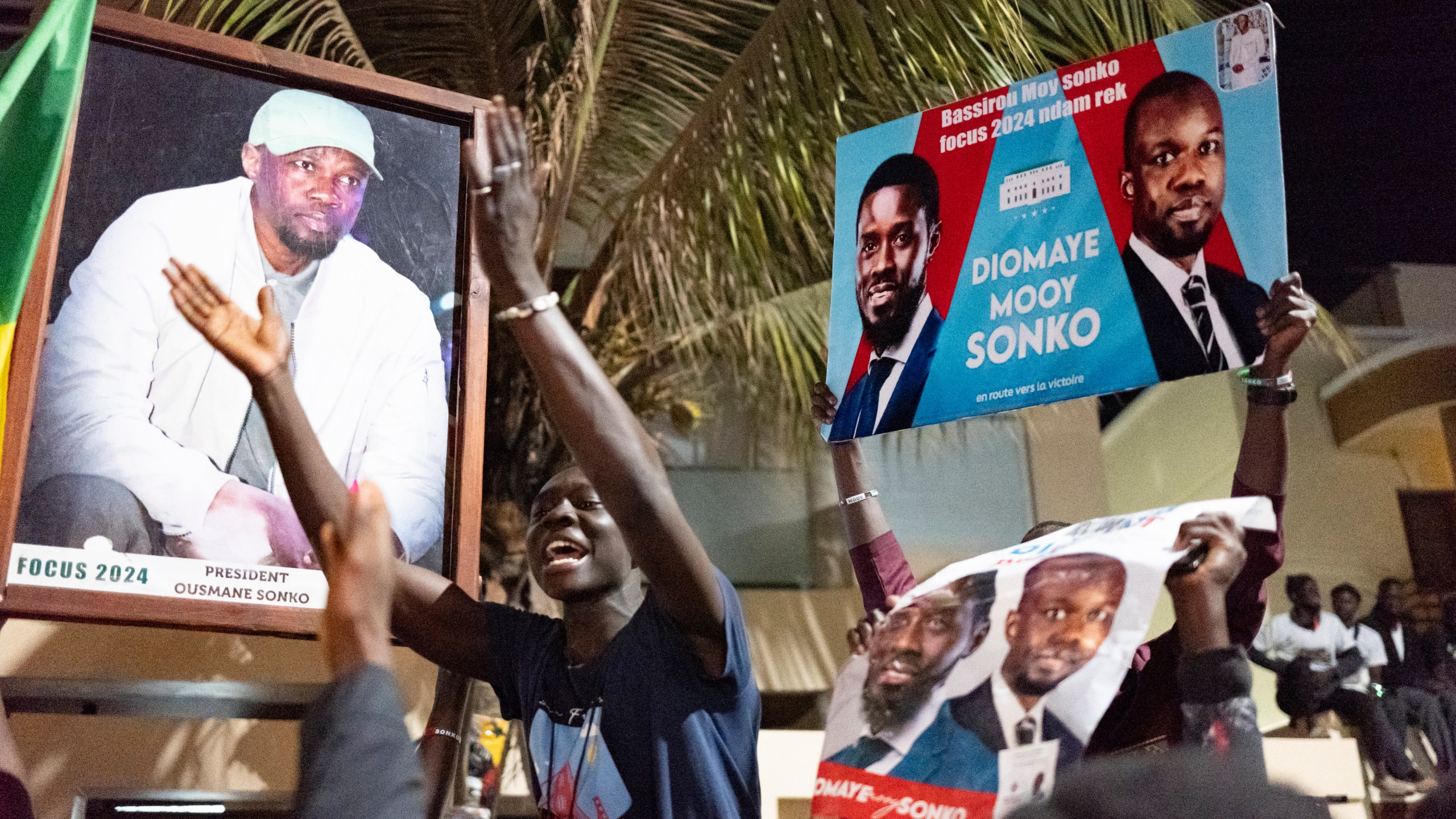 Supporters celebrate the release of Senegal's top opposition leader Ousmane Sonko and his key ally Bassirou Diomaye Faye outside Sonko's home in Dakar, Senegal, Thursday, March 14, 2024. Sonko had been in prison since July 2023 and has fought a prolonged legal battle to run for president in the March 24 election.(AP Photo/Sylvain Cherkaoui)