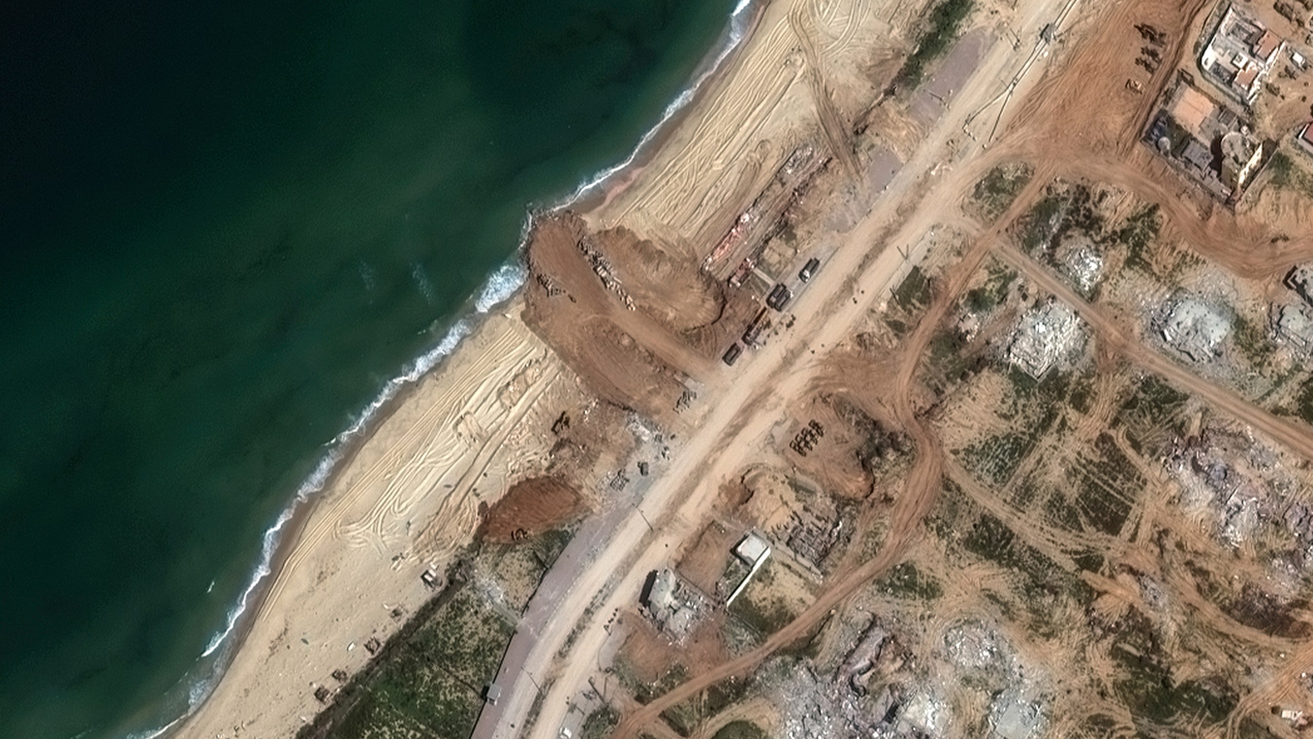 This satellite image released by Maxar Technologies on Thursday, March 14, 2024 shows a new jetty is under construction on the Gaza coastline just south of Gaza City on Tuesday, March 12, 2024. (Satellite image ©2024 Maxar Technologies, via AP)