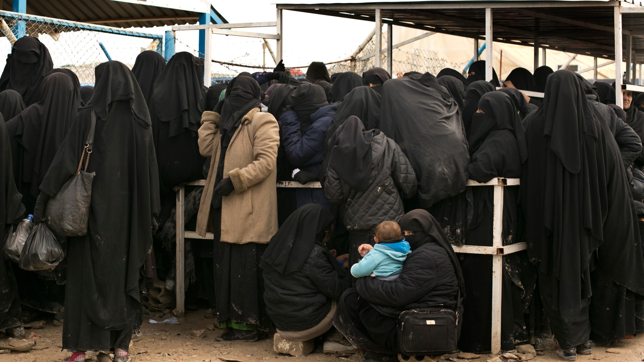 FILE - Women residents from former Islamic State-held areas in Syria line up for aid supplies at Al-Hol camp in Hassakeh province, Syria, March 31, 2019. Syria’s civil war has entered its 14th year on Friday March 15, 2024, a somber anniversary in a long-frozen conflict. The country is effectively carved up into areas controlled by the Damascus government, various opposition groups and Kurdish forces. (AP Photo/Maya Alleruzzo, File)