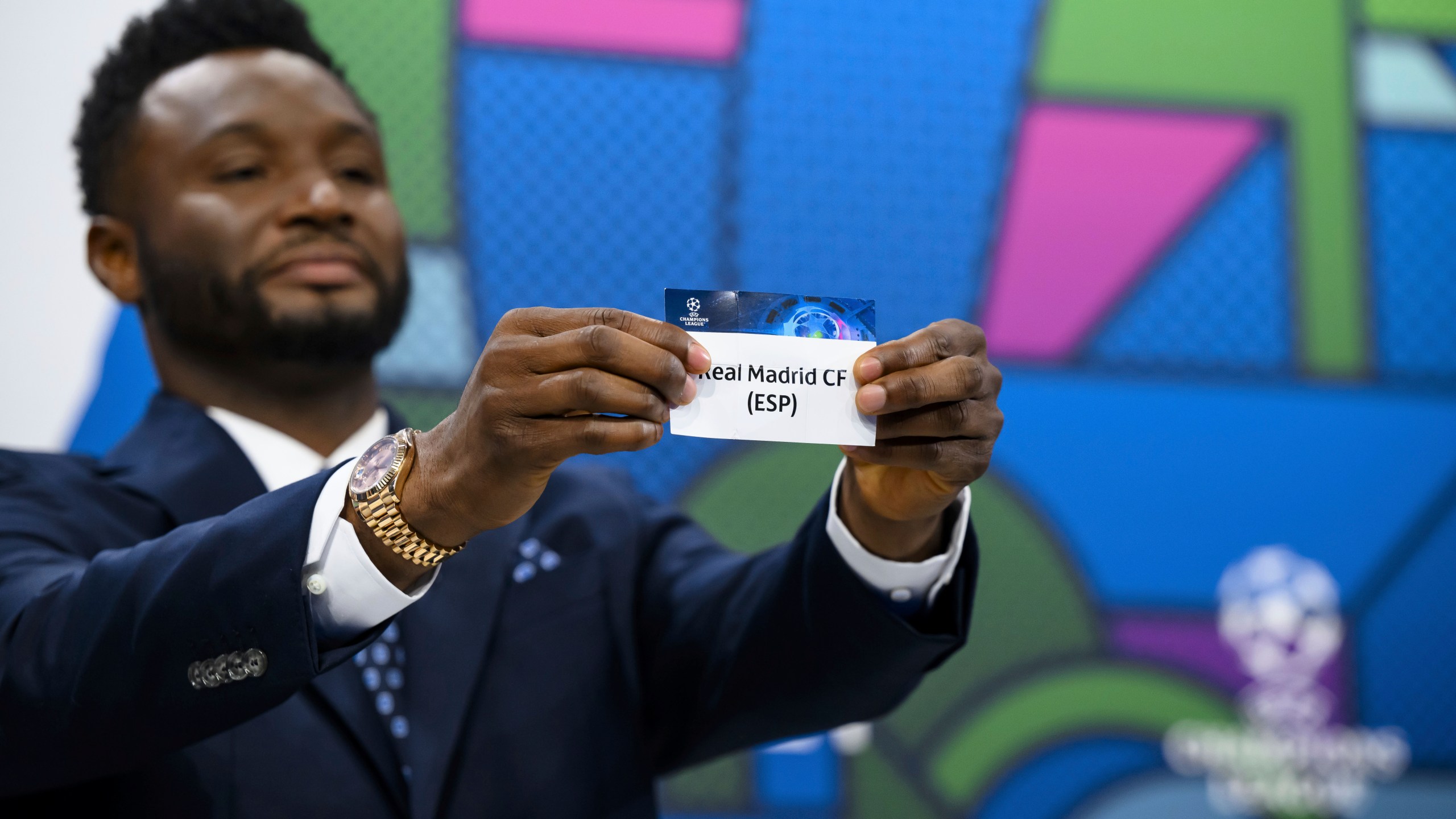 Former soccer player of Nigeria and ambassador for the UEFA Champions League final in London John Obi Mikel shows a ticket with Spanish soccer team Real Madrid CF name during the quarter-final draw of the UEFA Champions League 2023/24, at the UEFA Headquarters in Nyon, Switzerland, Friday, March 15, 2024. Real Madrid CF will face Manchester City FC in the quarter-final of the 2023/2024 UEFA Champions League. (Jean-Christophe Bott/Keystone via AP)