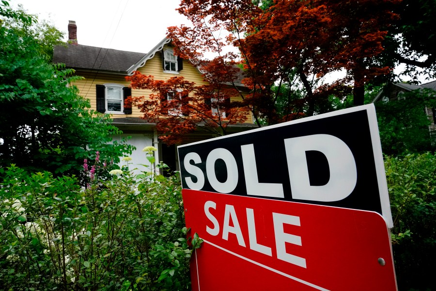 FILE - A sale sign stands outside a home in Wyndmoor, Pa., Wednesday, June 22, 2022. The National Association of Realtors has agreed on Friday, March 15, 2024, to pay $418 million and change its rules to settle lawsuits claiming homeowners have been unfairly forced to pay artificially inflated agent commissions when they sold their home. (AP Photo/Matt Rourke, File)