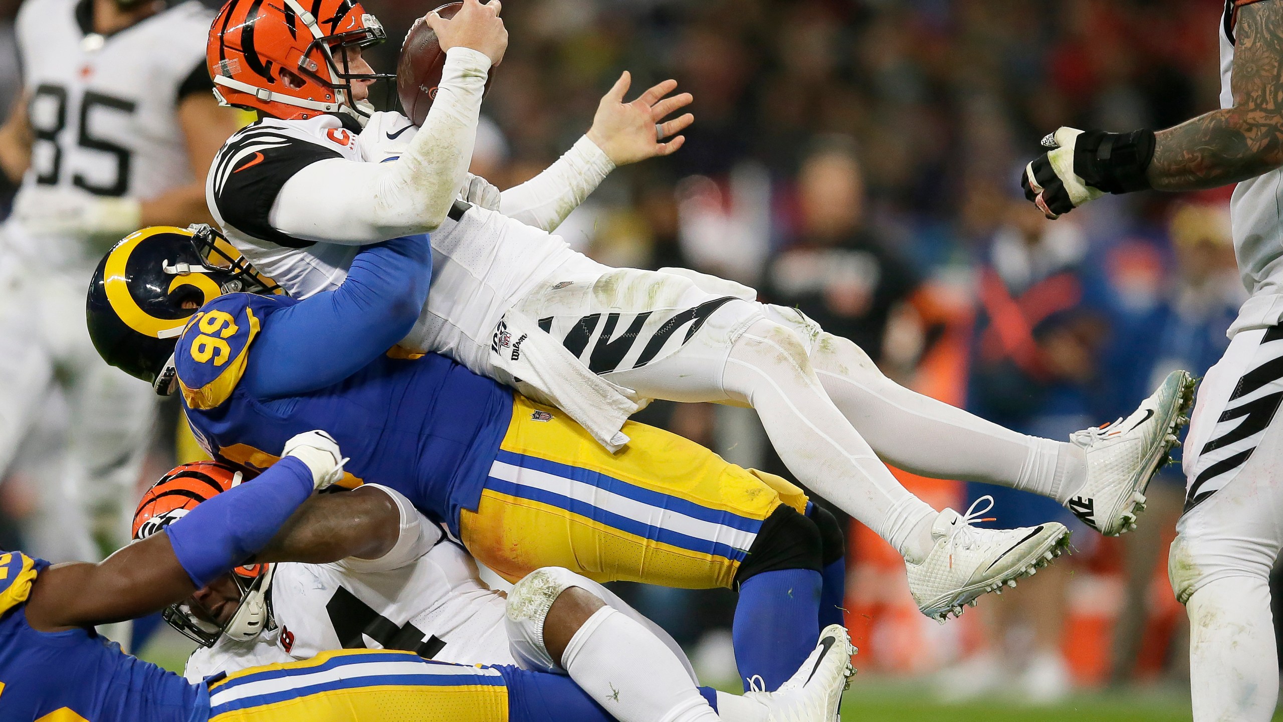 FILE - Cincinnati Bengals quarterback Andy Dalton, top, is sacked by Los Angeles Rams defensive tackle Aaron Donald during the second half of an NFL football game, Sunday, Oct. 27, 2019, at Wembley Stadium in London. Defensive lineman Aaron Donald has announced his retirement after a standout 10-year career with the Los Angeles Rams. The three-time AP NFL Defensive Player of the Year made his surprising announcement on social media Friday, March 15, 2024. (AP Photo/Tim Ireland, File)