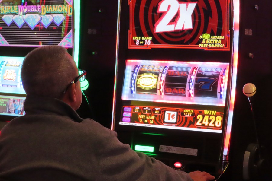 A gambler plays a slot machine at the Ocean Casino Resort in Atlantic City N.J. on Nov. 29, 2023. On March 15, 2024, New Jersey gambling regulators released figures showing Atlantic City's nine casinos, the three horse tracks that accept sports bets, and their online partners won over $461 million in February, an increase of 12% from February 2023. (AP Photo/Wayne Parry)