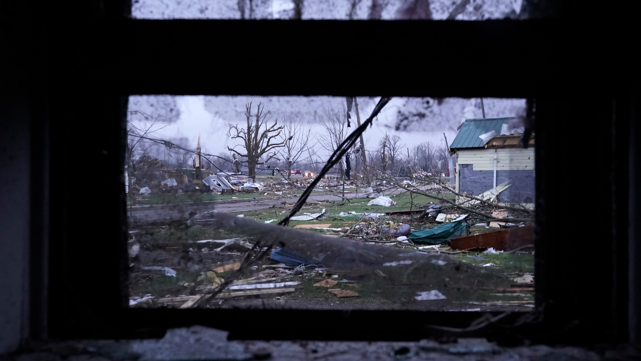 Debris is visible through the window of a damaged home following severe storms Friday, March 15, 2024, in Lakeview, Ohio. (AP Photo/Joshua A. Bickel)