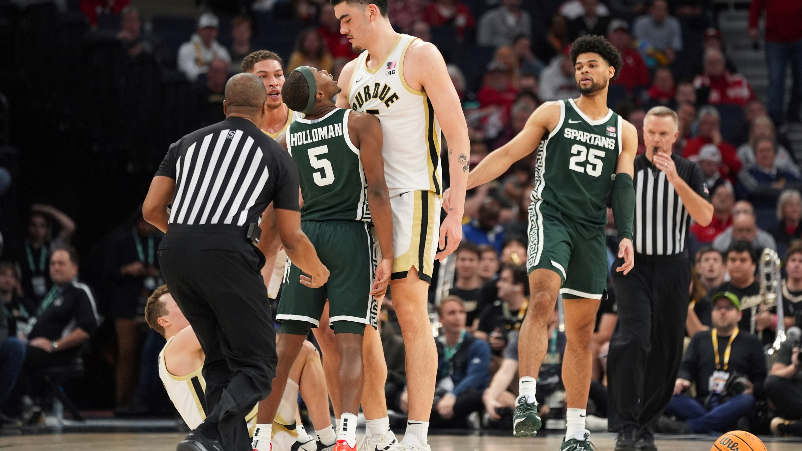 Michigan State guard Tre Holloman (5) and Purdue center Zach Edey, center, get into an altercation during the second half of an NCAA college basketball game in the quarterfinal round of the Big Ten Conference tournament, Friday, March 15, 2024, in Minneapolis. (AP Photo/Abbie Parr)