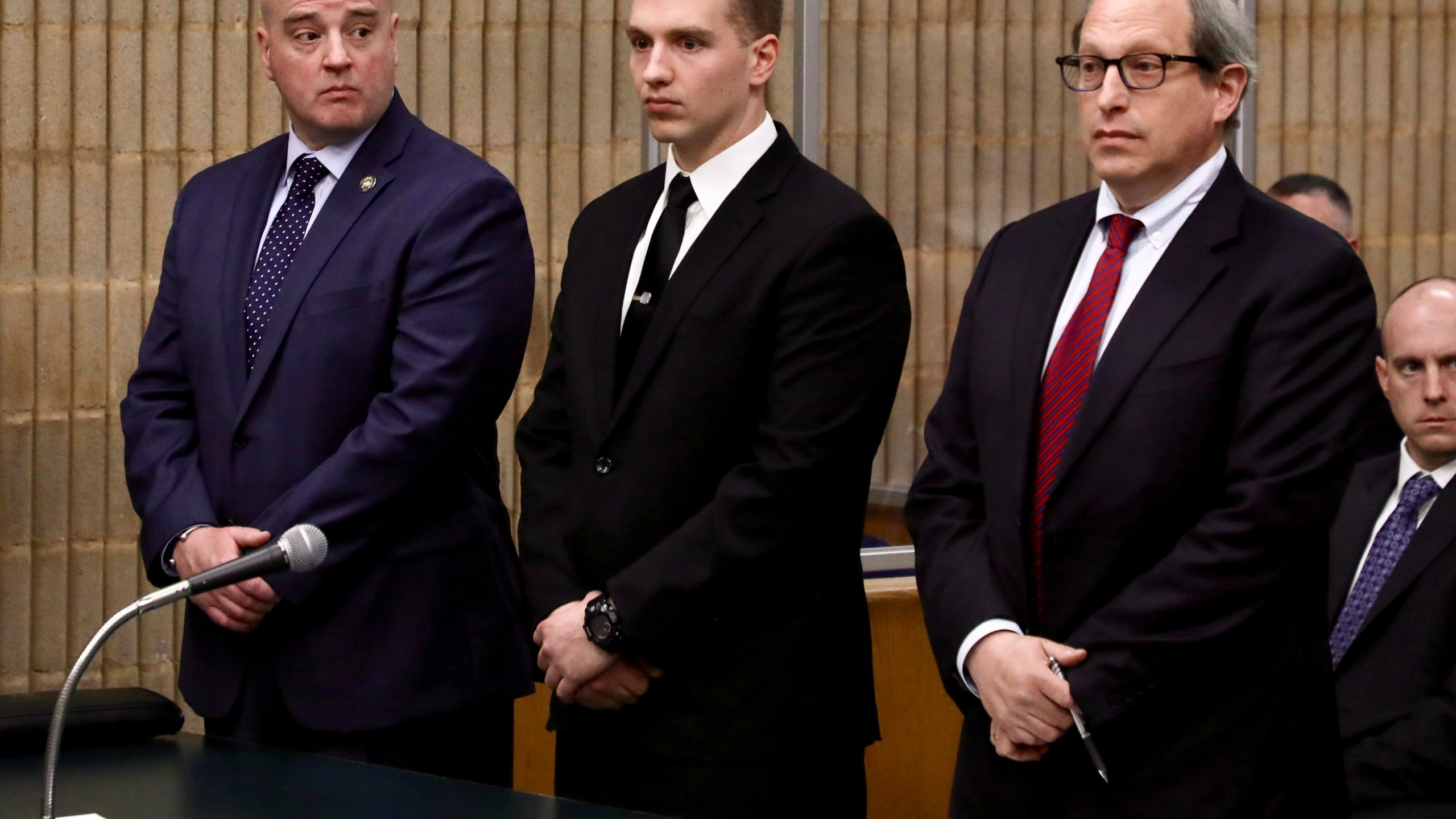 FILE - Connecticut State Trooper Brian North, center, flanked by Andrew Matthews, president of the Connecticut State Police Union, left, and attorney Jeffrey Ment, appears in Milford Superior Court Tuesday, May 3, 2022, in Milford, Conn. North was acquitted of manslaughter charges Friday, March 15, 2024, in the death of Mubarak Soulemane, a community college student with mental illness. (Sean Fowler/Hartford Courant via AP, Pool, File)