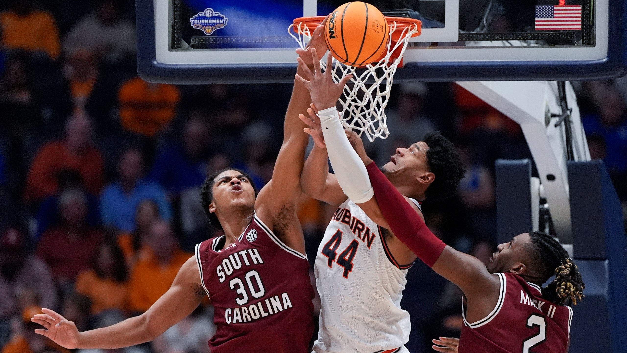 Auburn center Dylan Cardwell (44) battles South Carolina forwards Collin Murray-Boyles (30) and B.J. Mack (2) for a rebound during the first half of an NCAA college basketball game at the Southeastern Conference tournament Friday, March 15, 2024, in Nashville, Tenn. (AP Photo/John Bazemore)