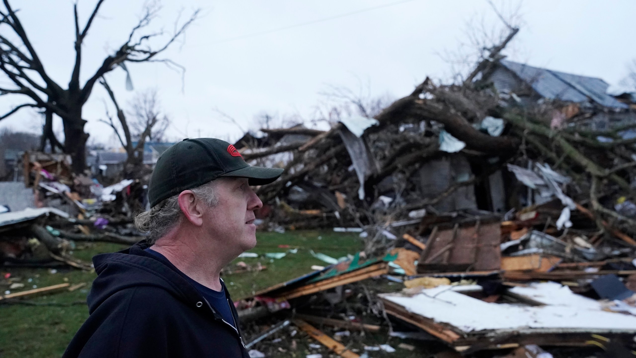 Greg McDougle walks near debris Friday, March 15, 2024, following a severe storm in Lakeview, Ohio. (AP Photo/Joshua A. Bickel)