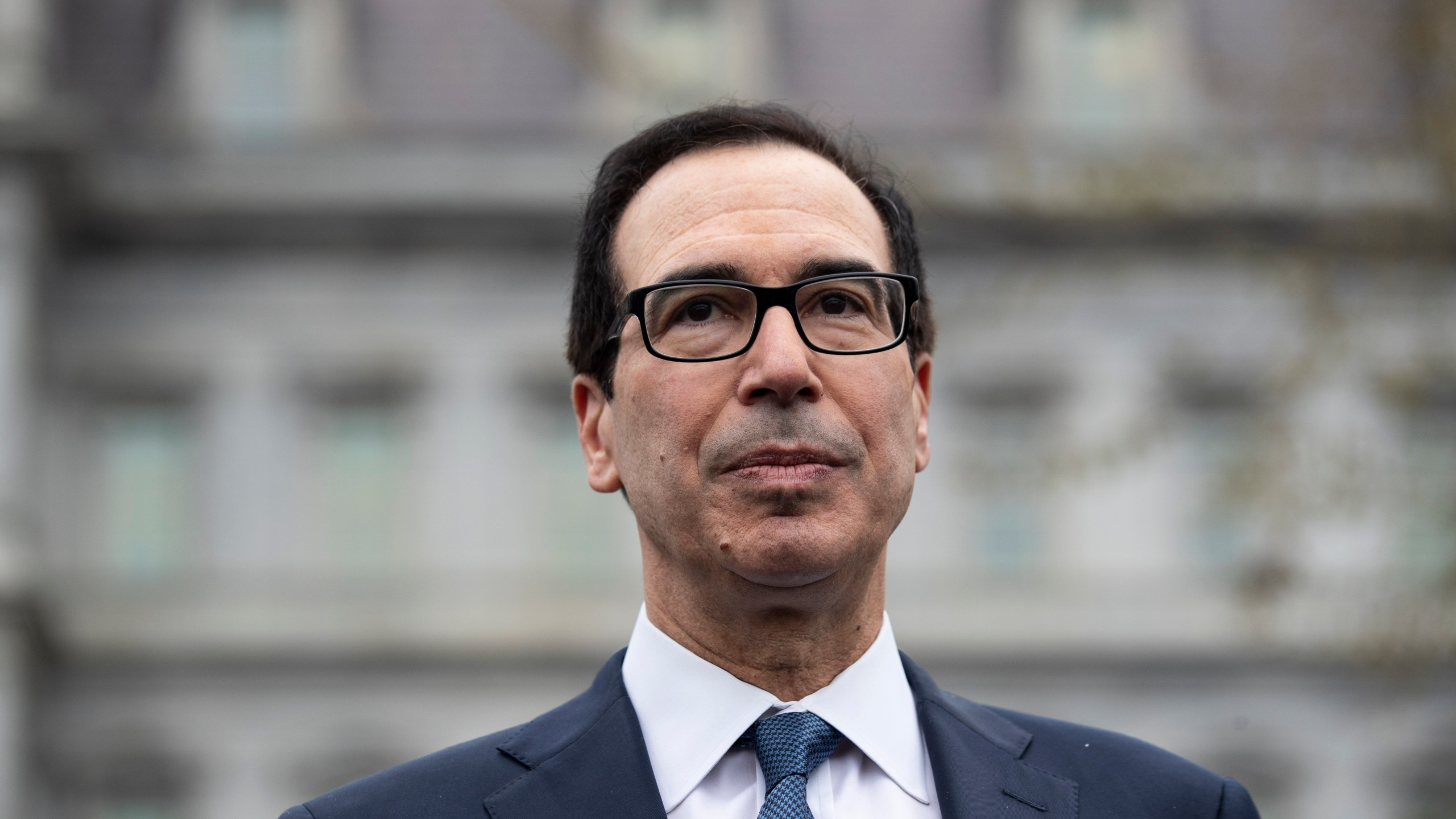 FILE - Former Treasury Secretary Steve Mnuchin speaks with reporters at the White House, March 13, 2020, in Washington. Mnuchin is interested in buying TikTok, just days after his investment firm led a $1 billion deal to inject life into a beaten-down bank.(AP Photo/Alex Brandon, File)