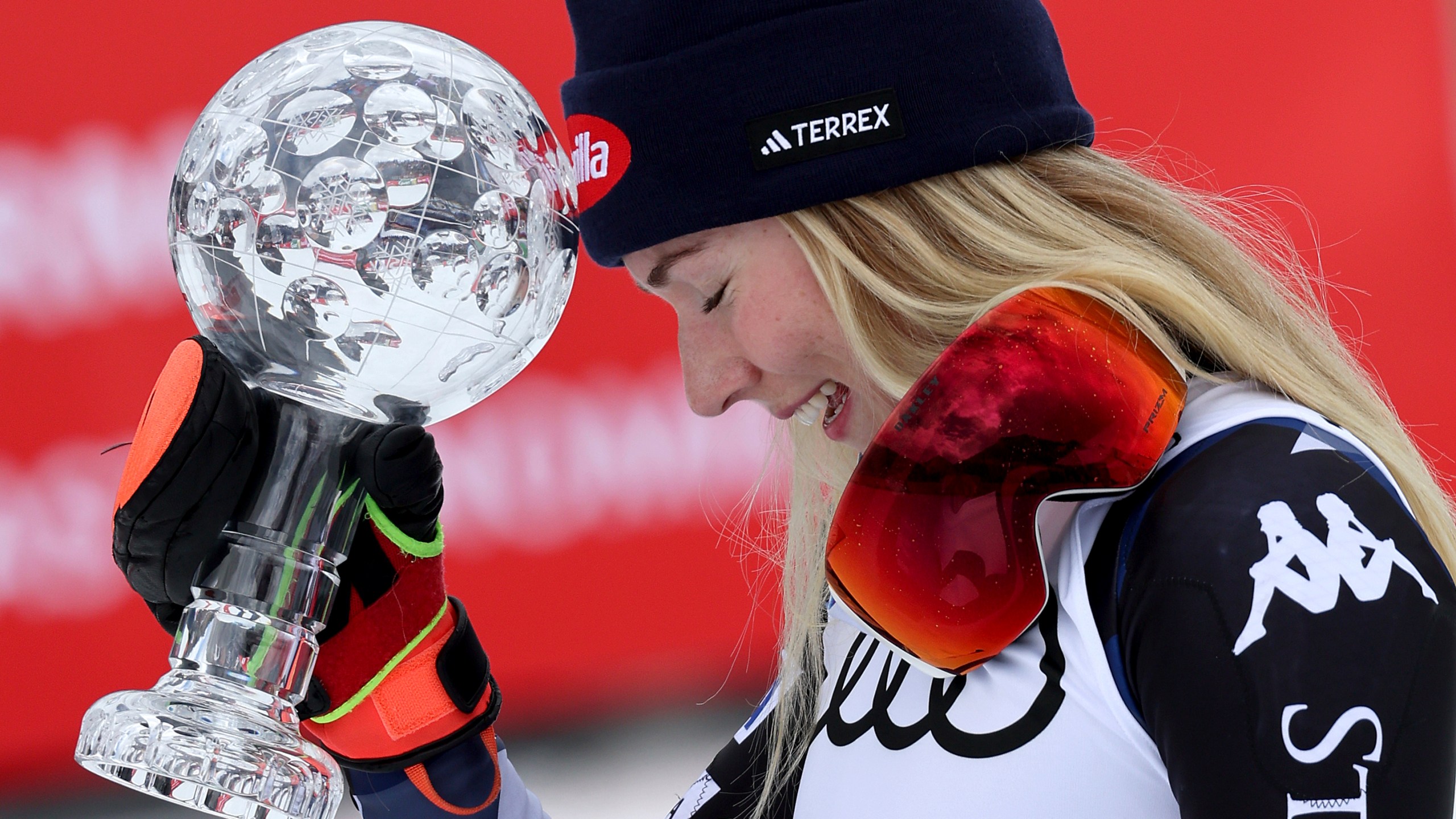 United States' Mikaela Shiffrin holds up the trophy for the alpine ski, women's World Cup slalom discipline, in Saalbach, Austria, Saturday, March 16, 2024. (AP Photo/Marco Trovati)