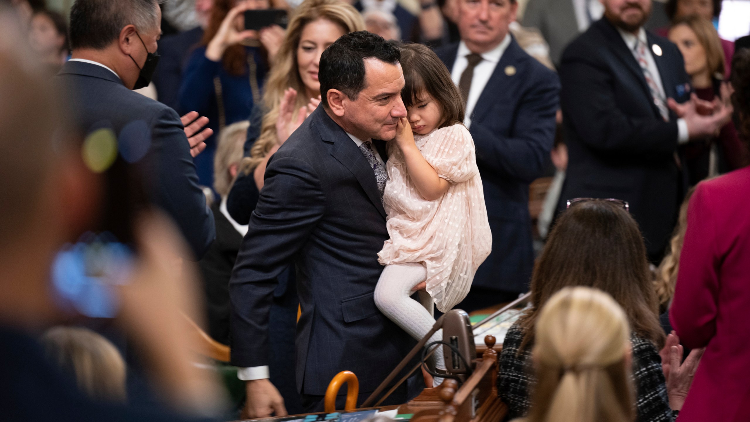 FILE - Assemblyman Anthony Rendon walks with his daughter Vienna before being sworn in as Speaker of the Assembly during the opening session of the California Legislature in Sacramento, Calif., Monday, Dec. 5, 2022. Rendon created the Select Committee on Happiness and Public Policy Outcomes to study how state policy can make Californians happier. (AP Photo/José Luis Villegas, Pool,File)