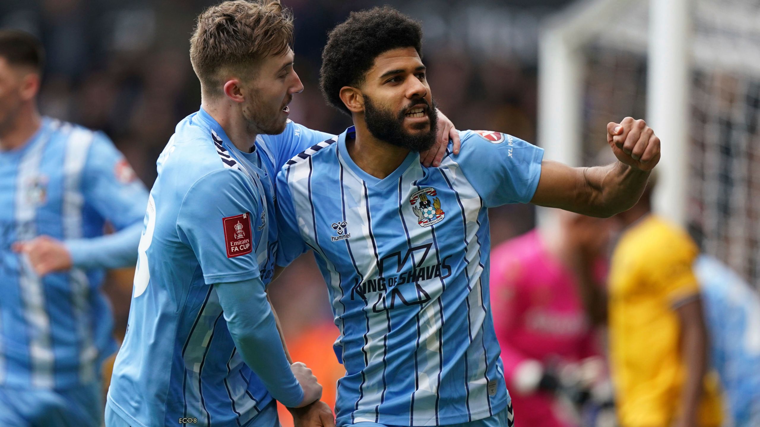 Coventry City's Ellis Simms, right, celebrates with teammate Josh Eccles after scoring his side's first goal of the game, during the English FA Cup quarter final match soccer match between Wolverhampton and Coventry City, at the Molineux, Wolverhampton, England, Saturday, March 16, 2024. (Mike Egerton/PA via AP)