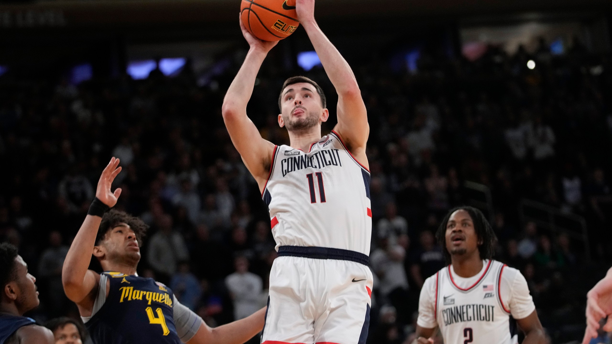 UConn forward Alex Karaban (11) goes to the basket against Marquette guard Stevie Mitchell (4) during the first half of an NCAA college basketball game in the championship of the Big East Conference tournament, Saturday, March 16, 2024, in New York. (AP Photo/Mary Altaffer)