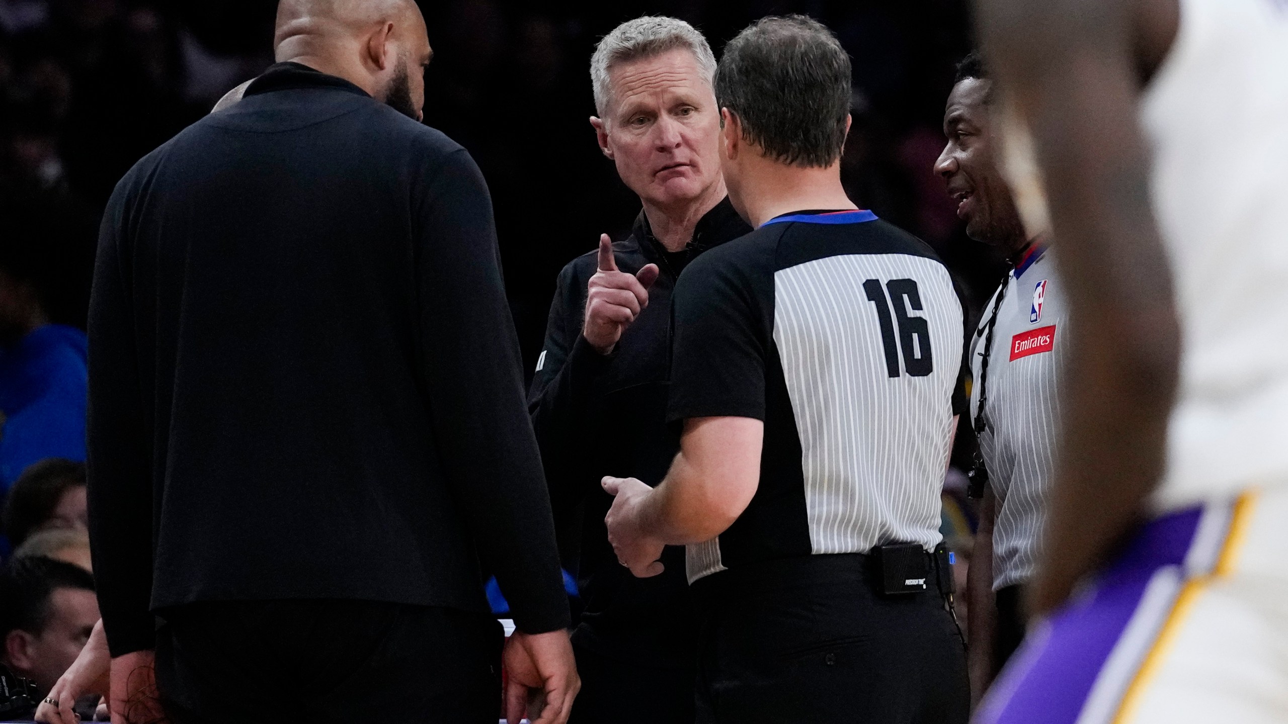 Los Angeles Lakers head coach Darvin Ham, left, and Golden State Warriors head coach Steve Kerr, center, talk with referee David Guthrie (16) after a shot clock malfunction during the second half of an NBA basketball game in Los Angeles, Saturday, March 16, 2024. (AP Photo/Ashley Landis)
