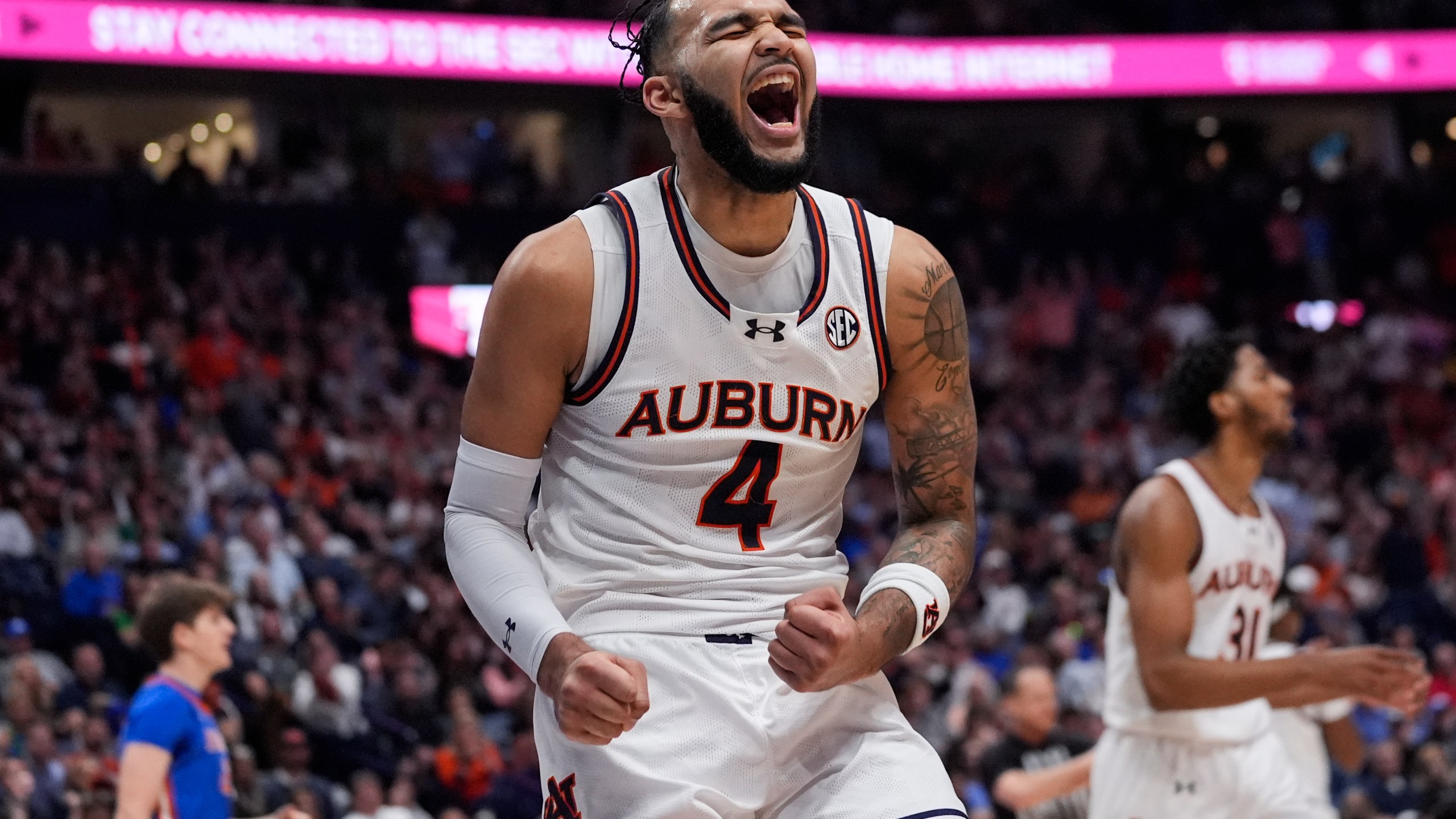 Auburn forward Johni Broome (4) reacts after a basket during the first half of an NCAA college basketball game against Florida in the fianls of the Southeastern Conference tournament Sunday, March 17, 2024, in Nashville, Tenn. (AP Photo/John Bazemore)
