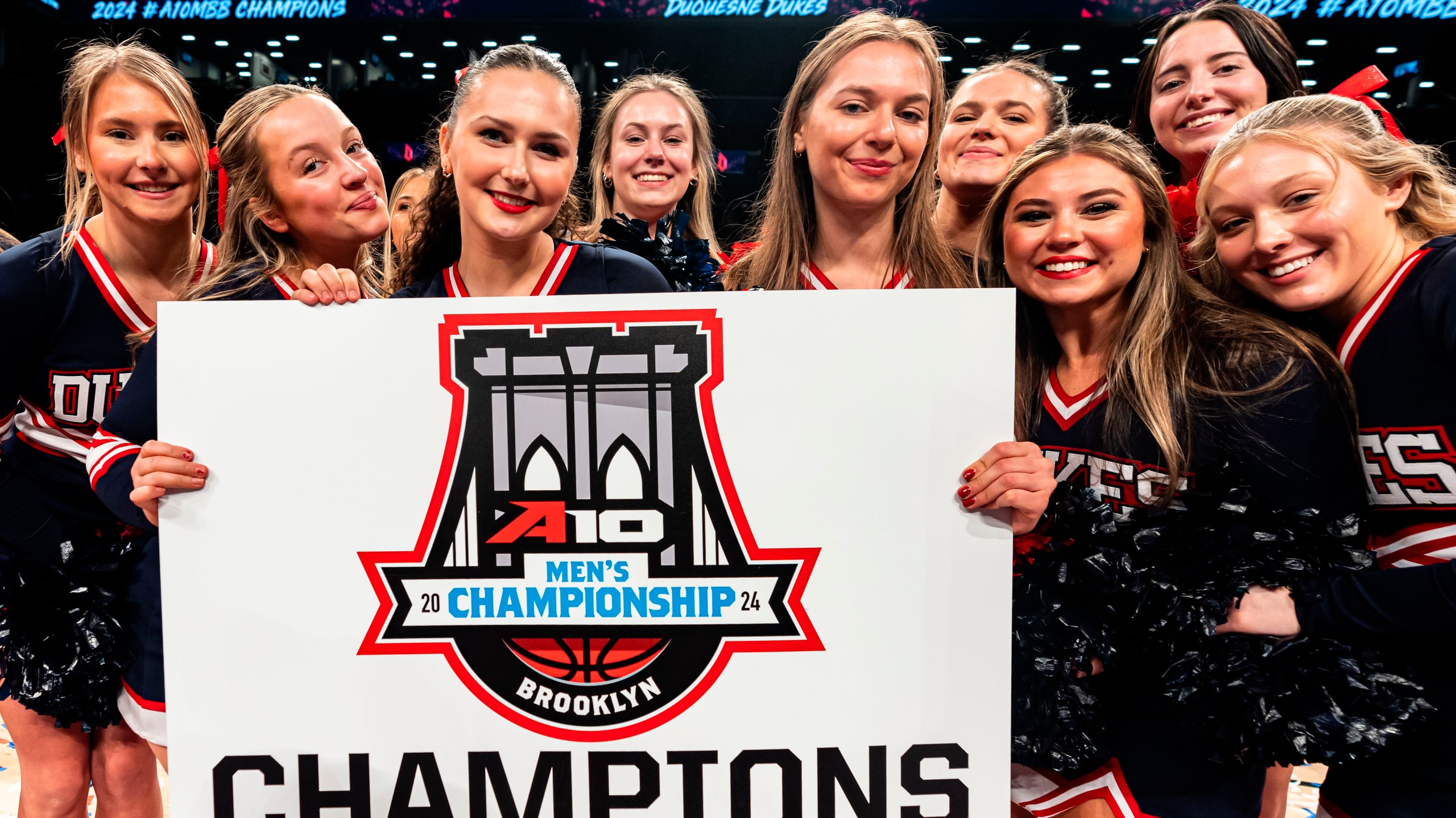 Duquesne cheerleaders pose for a photo after an NCAA college basketball game against Virginia Commonwealth in the championship of the Atlantic 10 Conference tournament Sunday, March 17, 2024, in New York. (AP Photo/Peter K. Afriyie)