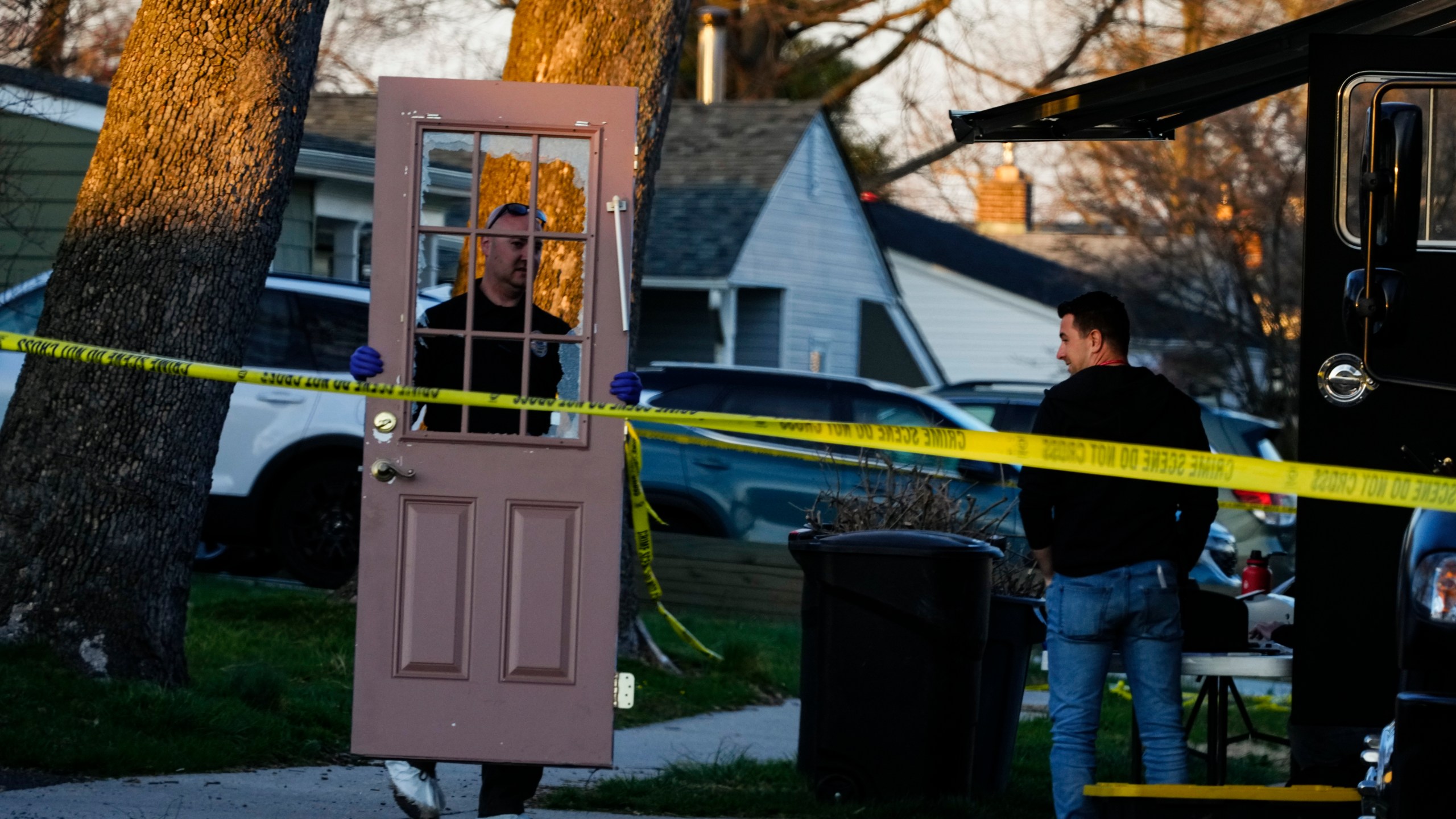 An investigator collects evidence from the scene of a fatal shooting in Levittown, Pa., Saturday, March 16, 2024. Police say a man suspected of killing multiple family members in the Philadelphia area has been arrested in New Jersey. (AP Photo/Matt Rourke)