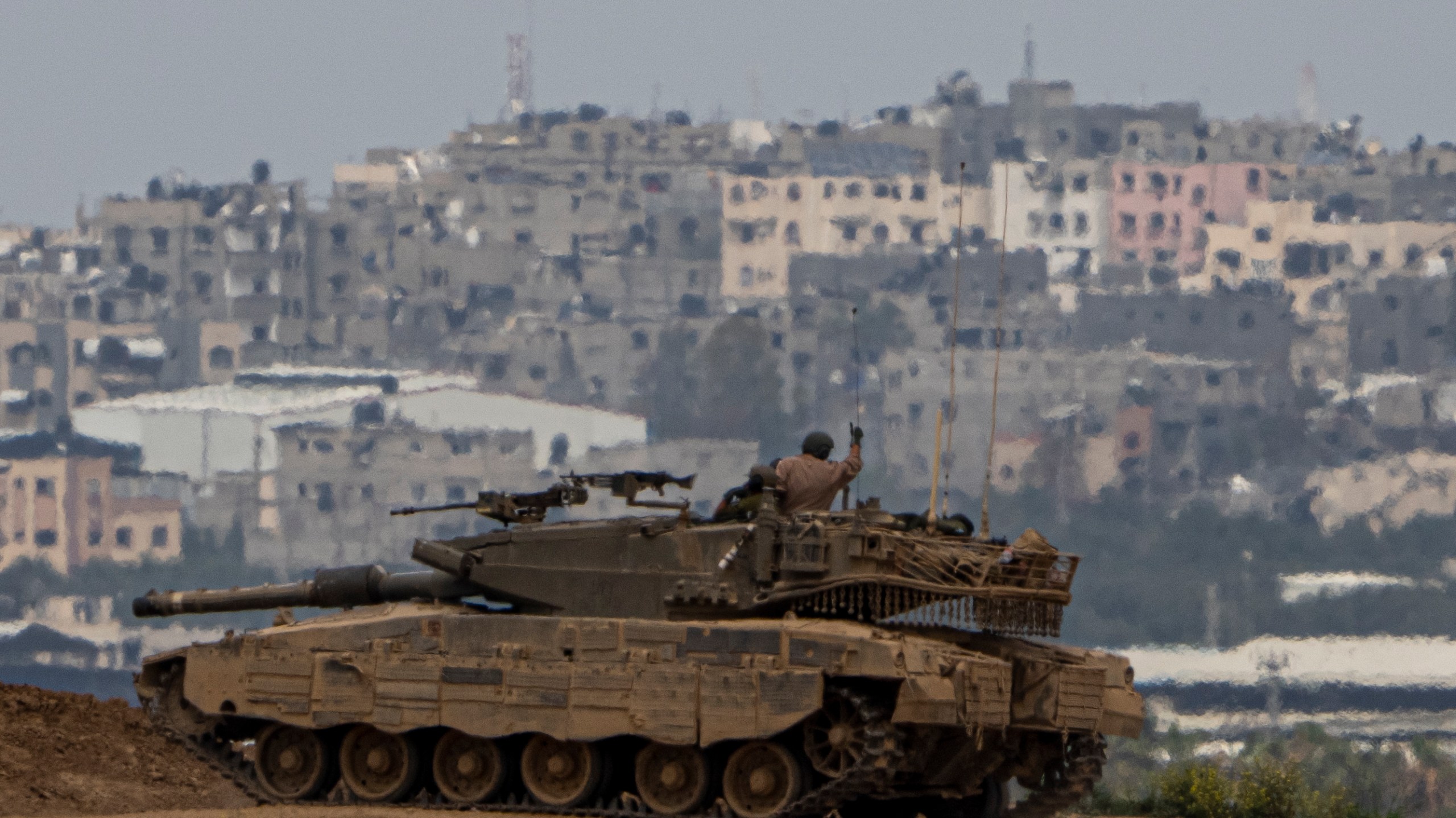 An Israeli soldier on top a tank on the border with the Gaza Strip, in southern Israel, Sunday, Sunday, March 17, 2024. (AP Photo/Ariel Schalit)
